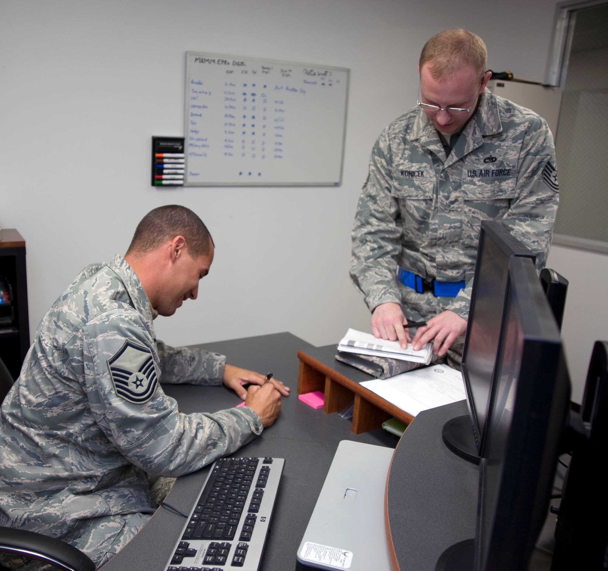 U.S. Air Force Tech. Sgt.  Kristopher Konicek, right, 35th Maintenance Group, Quality Assurance inspector, briefs Master Sgt. Spencer Mims, 35th Maintenance Squadron, on the inspection he conducted  at Misawa Air Base, Japan, Dec. 10, 2010. Quality Assurance flight directs all wing and base-level maintenance product improvement efforts designed to enhance mission readiness capabilities.  (U.S. Air Force photo by Tech. Sgt. Russell McBride/Released)