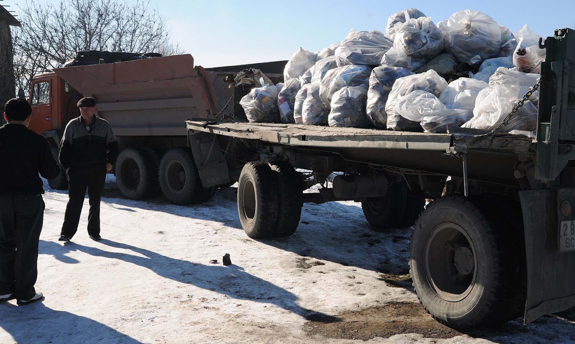 BISHKEK, Kyrgyzstan -  Airmen from the Transit Center at Manas teamed up with the local government, community residents and Koi-Tosh Non-Commissioned Officer Academy military members for a community clean up. More than 100, 30-gallon bags were filled with trash. The First Four, a professional organization made up of Airmen in the first four junior ranks, organized the event for the Enesay community, just outside Bishkek.  (U.S. Air Force photo/Staff Sgt. Nathan Bevier)