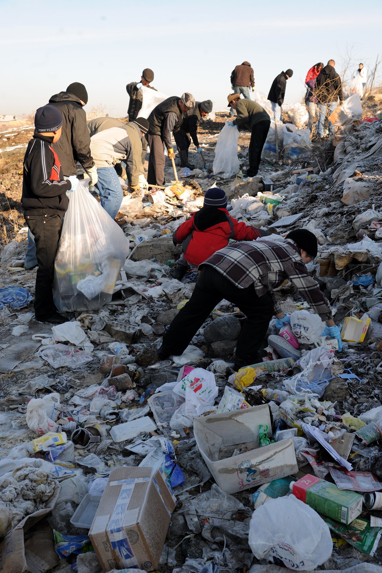 BISHKEK, Kyrgyzstan -  Airmen from the Transit Center at Manas teamed up with the local government, community residents and Koi-Tosh Non-Commissioned Officer Academy military members for a community clean up. More than 100, 30-gallon bags were filled with trash. The First Four, a professional organization made up of Airmen in the first four junior ranks, organized the event for the Enesay community, just outside Bishkek.  (U.S. Air Force photo/Staff Sgt. Nathan Bevier)