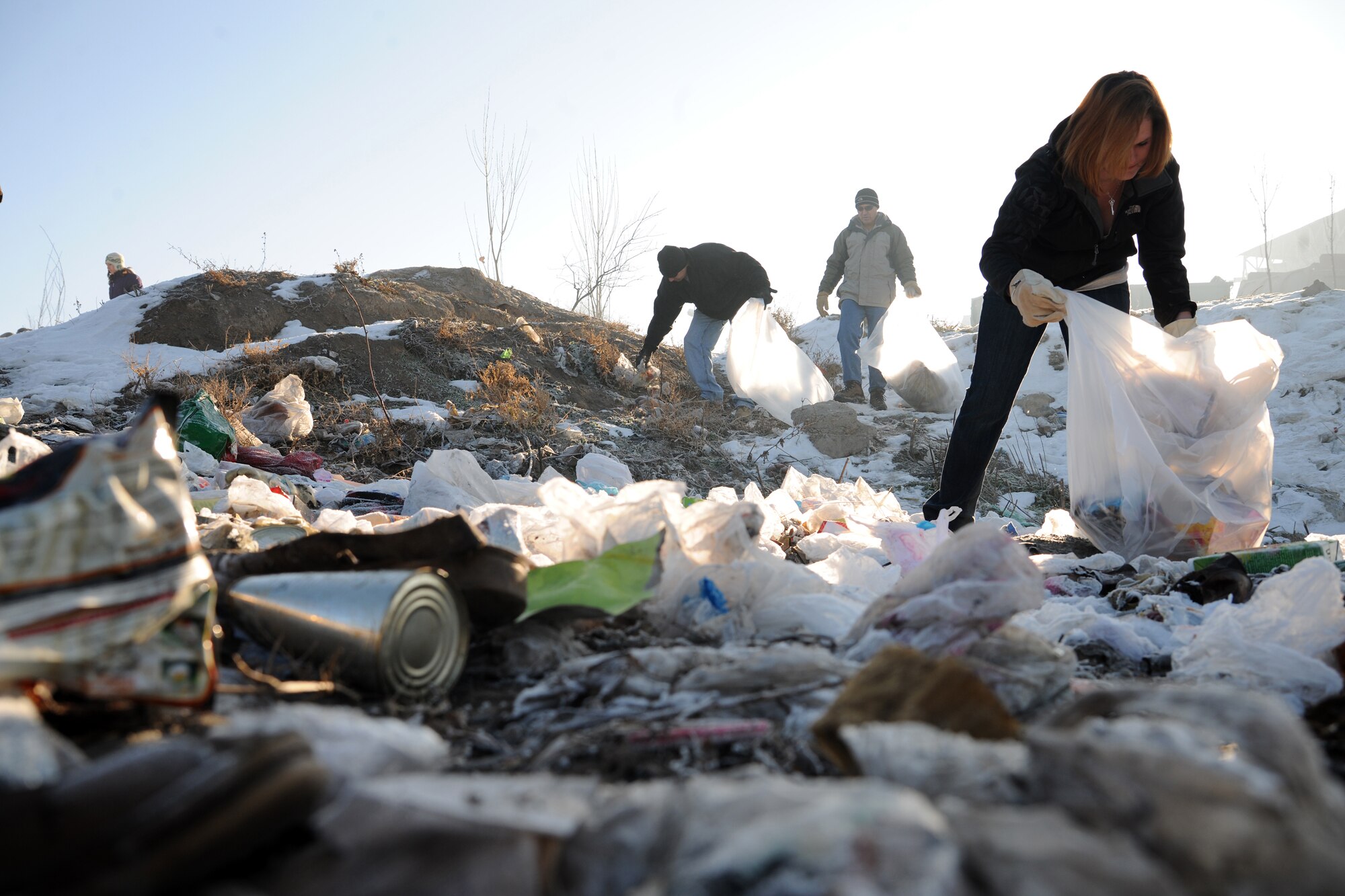 BISHKEK, Kyrgyzstan -  Airmen from the Transit Center at Manas teamed up with the local government, community residents and Koi-Tosh Non-Commissioned Officer Academy military members for a community clean up. More than 100, 30-gallon bags were filled with trash. The First Four, a professional organization made up of Airmen in the first four junior ranks, organized the event for the Enesay community, just outside Bishkek.  (U.S. Air Force photo/Staff Sgt. Nathan Bevier)