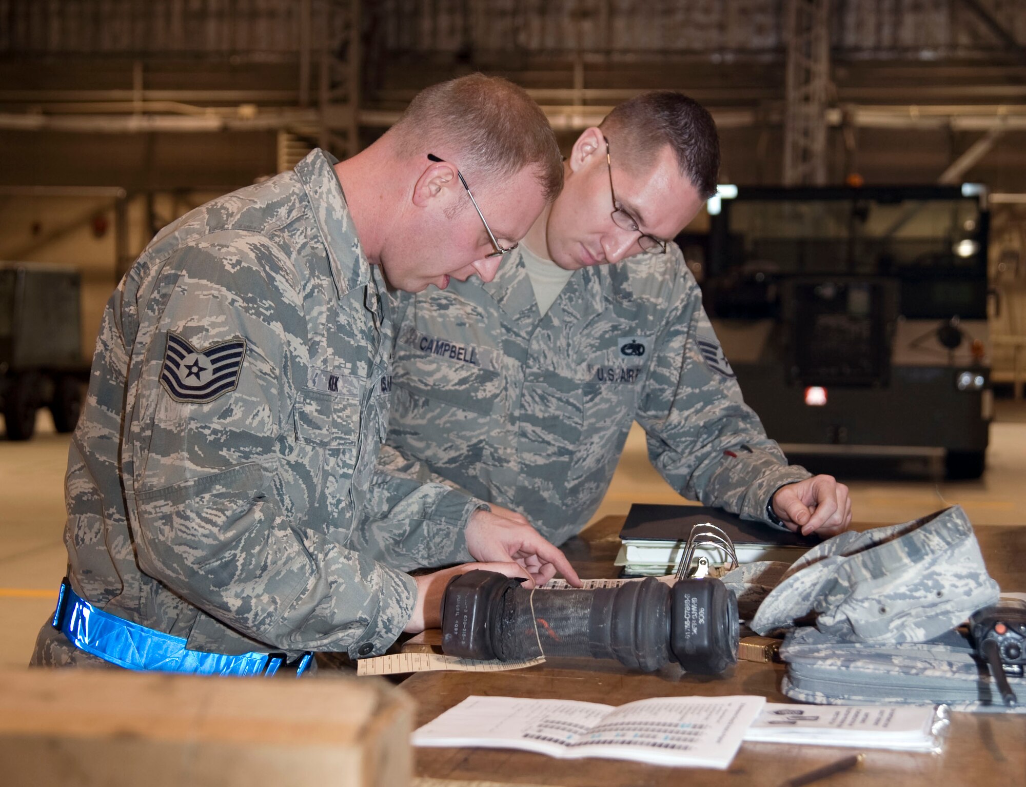 U.S. Air Force Tech. Sgt.  Kristopher Konicek, left, 35th Maintenance Group, quality assurance inspector, and Staff Sgt. Kennoth Campbell, 35th Maintenance Squadron, inspect equipment documentation of stored aircraft parts that have been removed from aircraft at Misawa Air Base, Japan, Dec. 10, 2010. Quality assurance inspections help the maintenance group to enhance quality of aircraft maintenance levels providing inspections evaluation data to leadership at all levels.  (U.S. Air Force photo by Tech. Sgt. Russell McBride/Released)