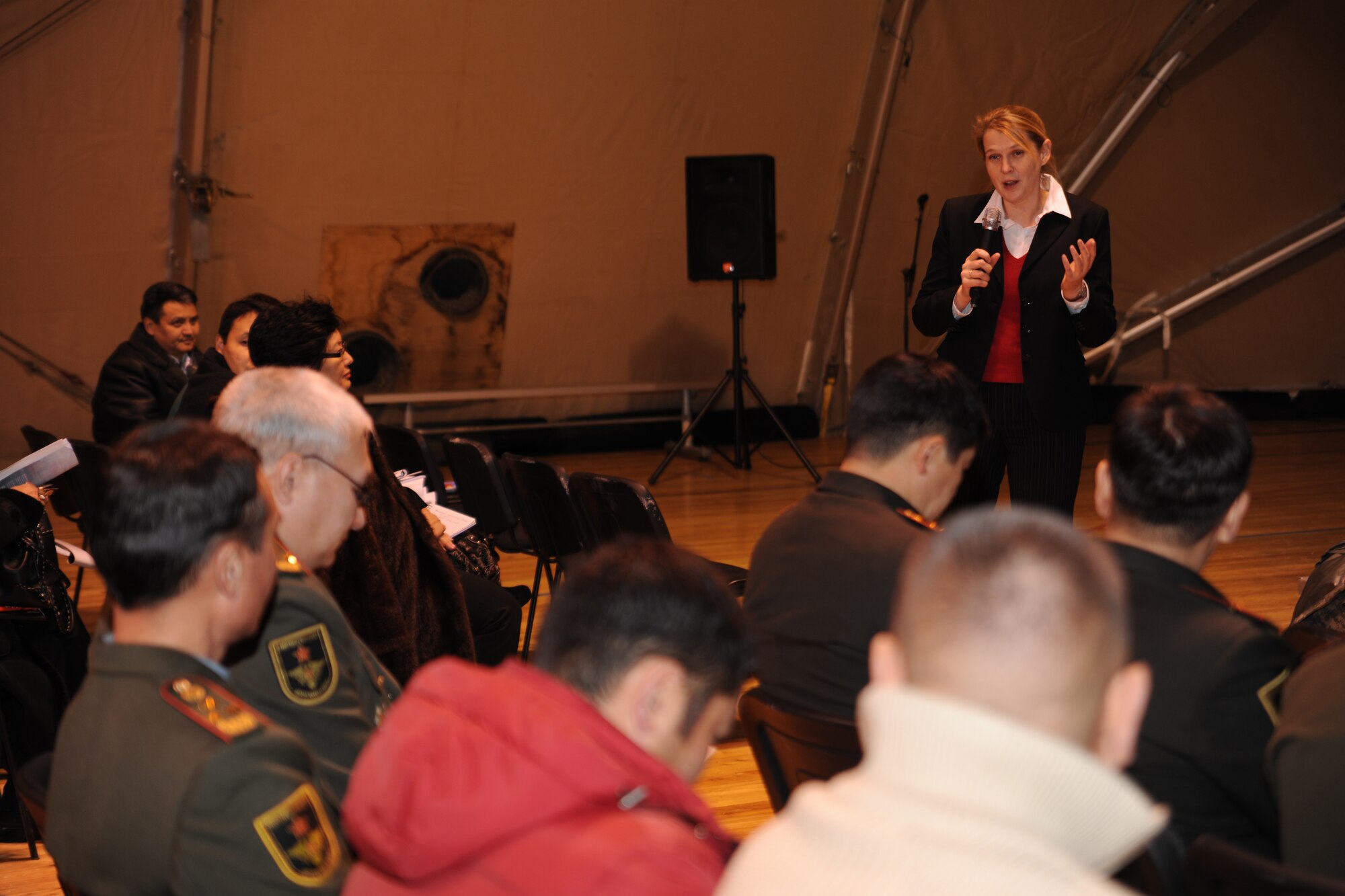 TRANSIT CENTER AT MANAS, Kyrgyzstan - Dr. Elena Kovaleva, Professor of International Security Studies, lectured and led a discussion about U.S. policy in Central Asia to Kyrgyz military graduates of the George C. Marshall Center, Germany, during an alumni event hosted by the U.S. Embassy Dec. 11. About 50 Kyrgyz members were given a Transit Center mission briefing, toured the installation and climbed aboard a C-17 Globemaster III. (U.S. Air Force photo/Staff Sgt. Nathan Bevier)
