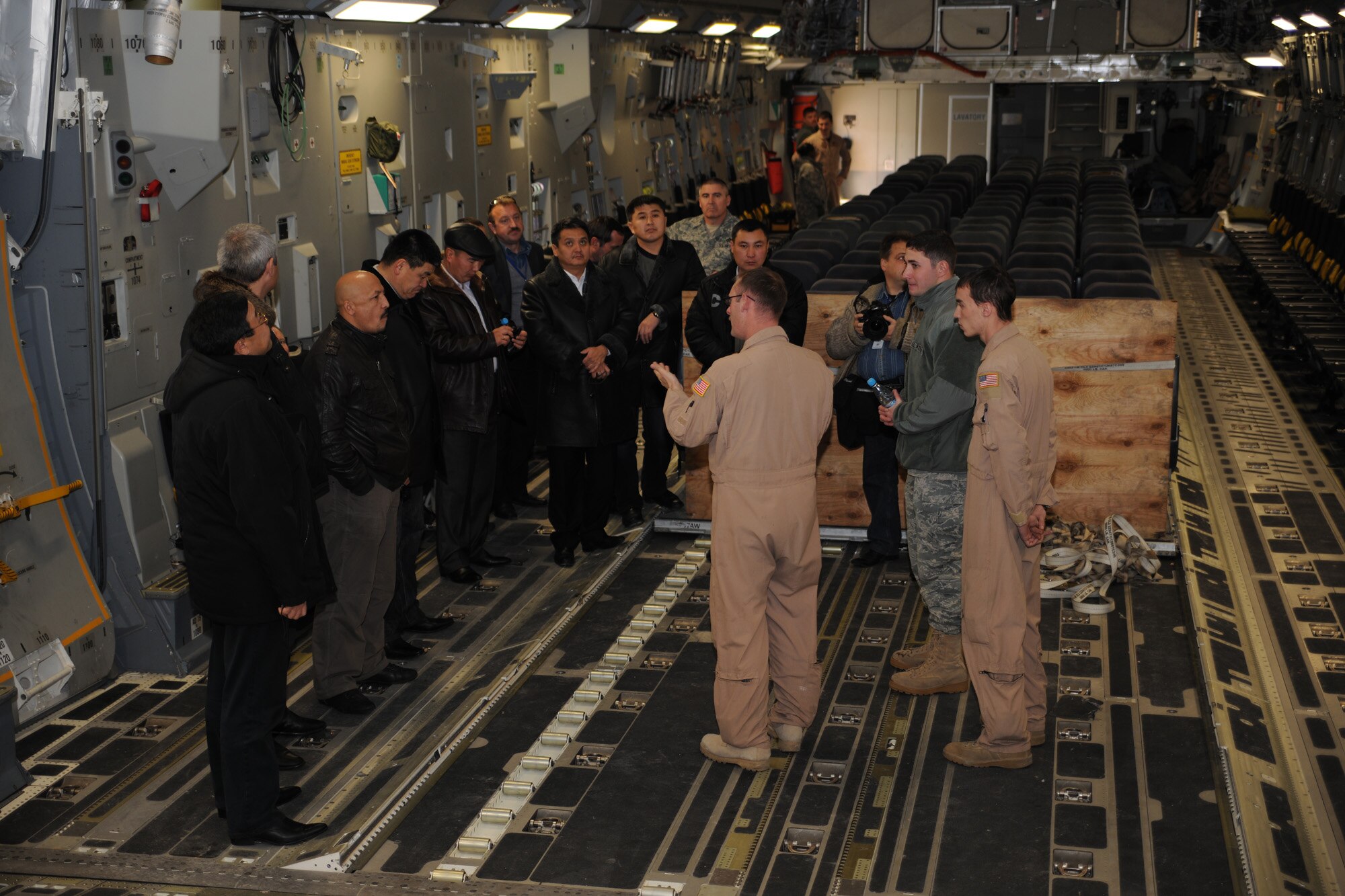 TRANSIT CENTER AT MANAS, Kyrgyzstan - Master Sgt. Jeffery Fareta, 376th Expeditionary Operations Group C-17 operations officer, shows the C-17 Globemaster III to Kyrgyz military graduates of the George C. Marshall Center, Germany.  The U.S. Embassy hosted the alumni event Dec. 11. (U.S. Air Force photo/Staff Sgt. Nathan Bevier)