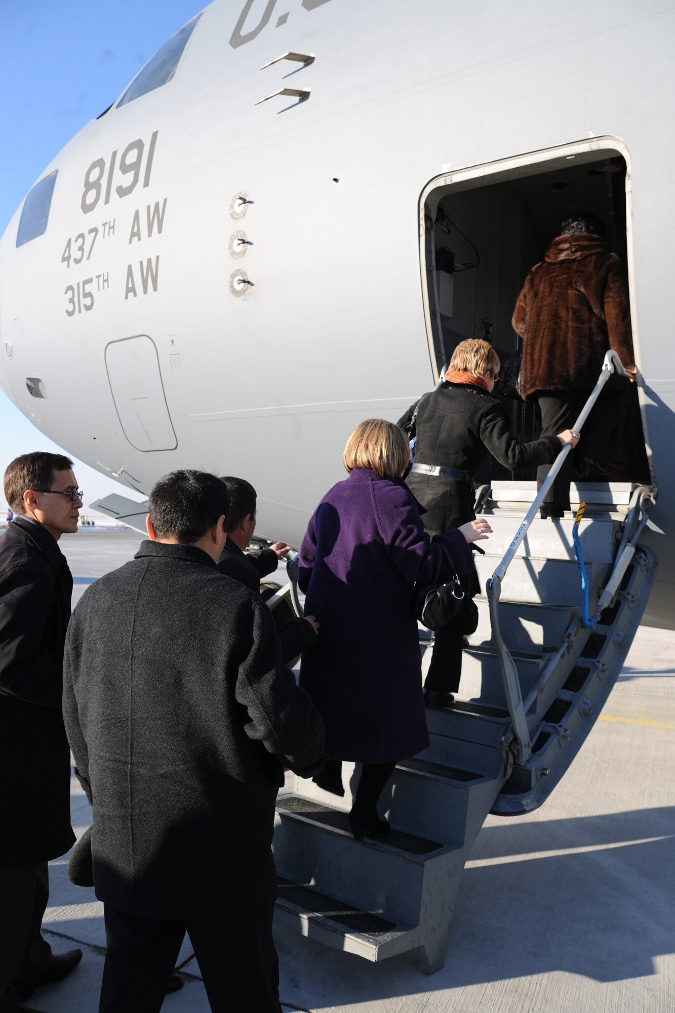 TRANSIT CENTER AT MANAS, Kyrgyzstan - Kyrgyz military graduates of the George C. Marshall Center climb aboard a C-17 Globemaster III during an alumni event hosted by the U.S. Embassy Dec. 11. About 50 Kyrgyz members were given a Transit Center mission briefing and a tour of the installation. (U.S. Air Force photo/Staff Sgt. Nathan Bevier)