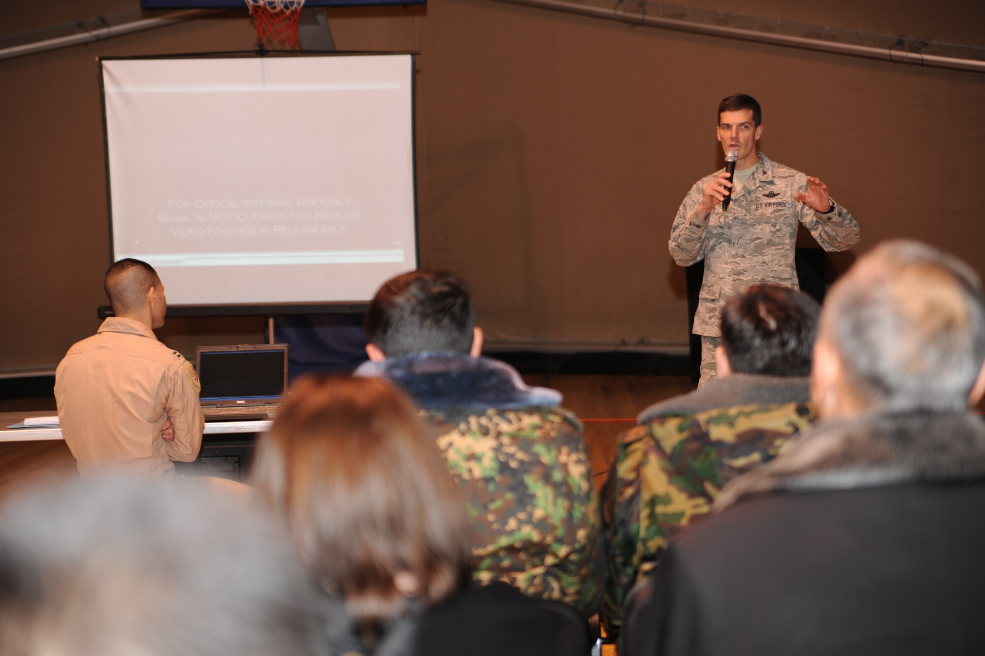 TRANSIT CENTER AT MANAS, Kyrgyzstan - Col. Dwight Sones, 376th Air Expeditionary Wing commander, explains the Transit Center's mission to Kyrgyz military graduates of the George C. Marshall Center Dec. 11. About 50 Kyrgyz alumni were given a tour of the installation and climbed aboard a C-17 Globemaster III. (U.S. Air Force photo/Staff Sgt. Nathan Bevier)