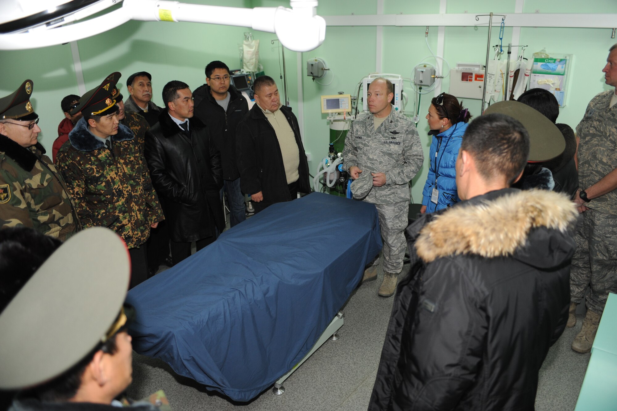 TRANSIT CENTER AT MANAS, Kyrgyzstan - Col. Brian Brandner, 376th Air Expeditionary Wing vice commander, provides a tour of the 376th Expeditionary Medical Group to Kyrgyz military graduates of the George C. Marshall Center, Germany, during an alumni event hosted by the U.S. Embassy Dec. 11. About 50 Kyrgyz members were given a Transit Center mission briefing, toured the installation and climbed aboard a C-17 Globemaster III.  (U.S. Air Force photo/Staff Sgt. Michael Schocker)