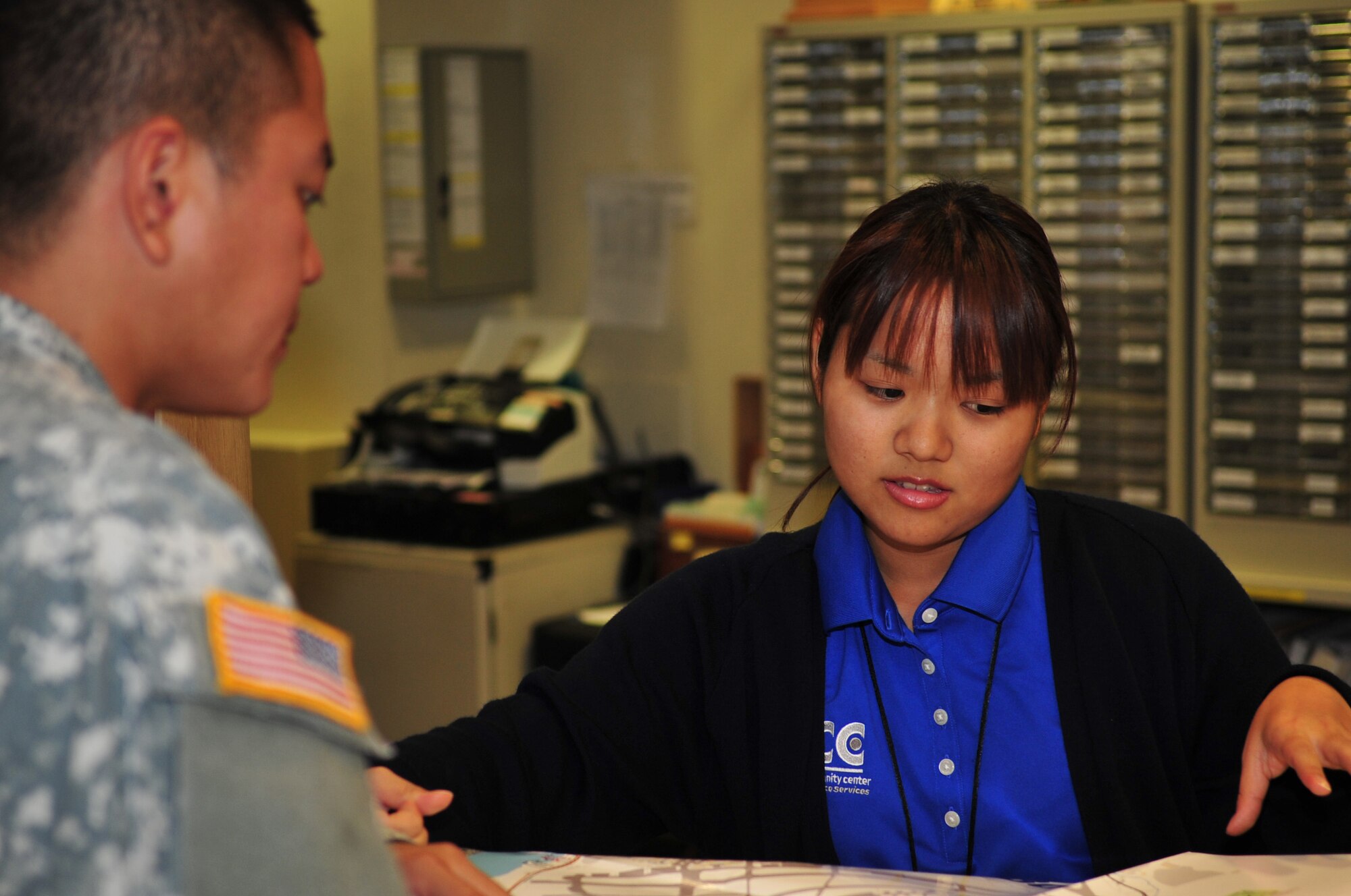 Megumi Yoshihama, a second-year student at the Kadena Language Institute on Okinawa, greets a customer at the front desk of the Schilling Community Center as part of an internship from Nov. 16 through Dec. 10. Six students from the institute participated in the internship in different areas of Kadena Air Base including the teen center, 18th Logistics Readiness Squadron, outdoor recreation center, Schilling Community Center, and Air Force and Navy public affairs offices. (Courtesy photo by Aona Higa)