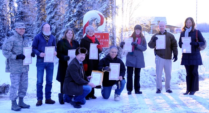 Col. Lynn Scheel joins North Pole Community leaders for formal ceremony designating a permanent candy cane marker as Santa's new address Dec. 3, 2010, North Pole, Alaska.  By keeping this program alive, North Pole can continue to recognize the efforts  of its originators at Eielson Air Force base.  Colonel Scheel is the 354th Fighter Wing Vice Wing Commander.  (U.S. Air Force photo by/Airman 1st Class Yash Rojas)