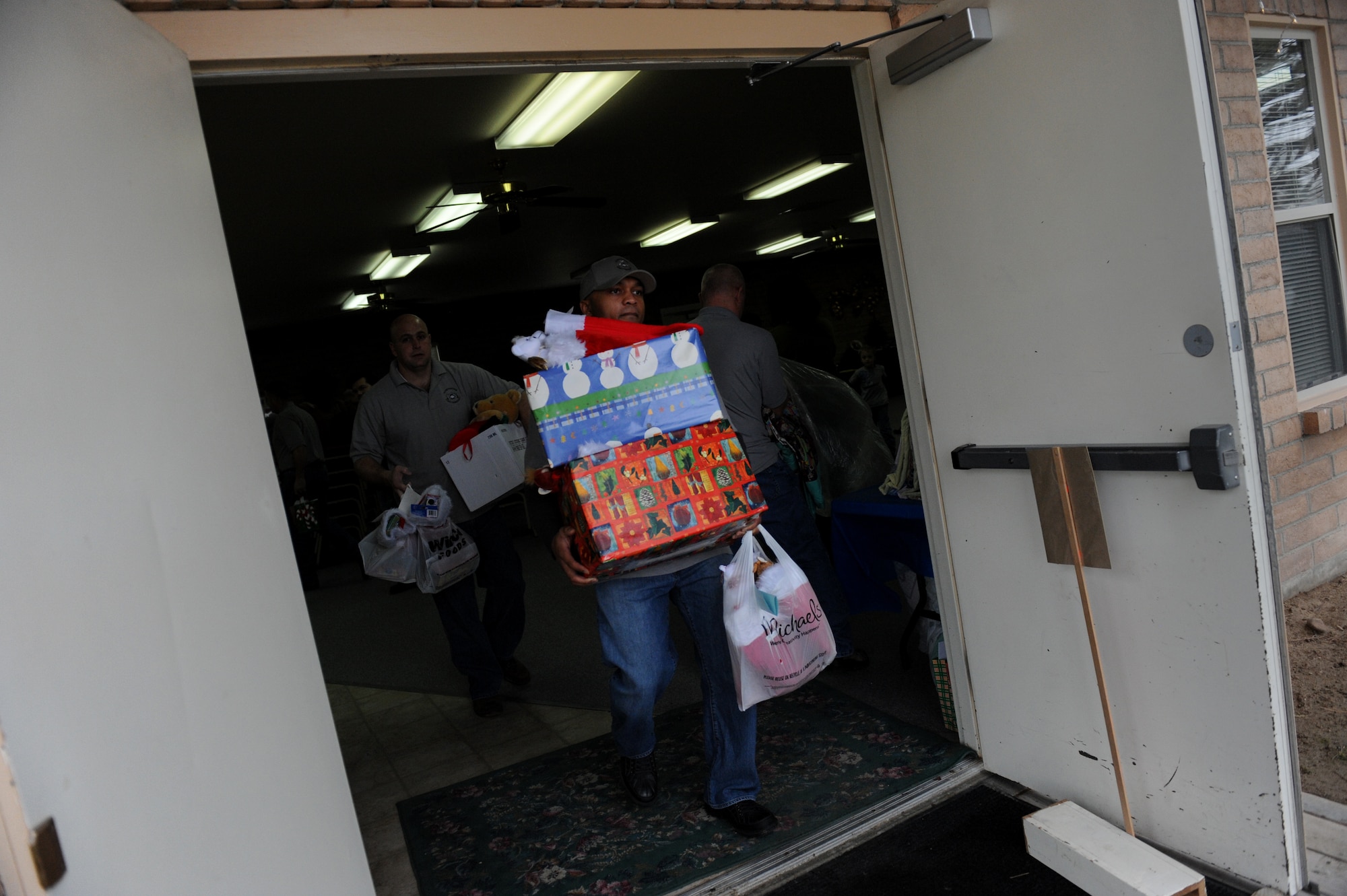 MOUNTAIN HOME AIR FORCE BASE, Idaho -- Master Sgt. LaJuan Fuller, 366th Maintenance Operations Squadron first sergeant, carries boxes full of toys and food items to be loaded into a truck during the Silver Crest II Annual Holiday Social in Nampa, Idaho, Dec. 11. Every year hundreds of toys and quilts and more than a thousand pounds of food are donated to help military families during the holiday season. This year the community donated $17,000. (U.S. Air Force photo by Staff Sgt. Gina Chiaverotti-Paige)