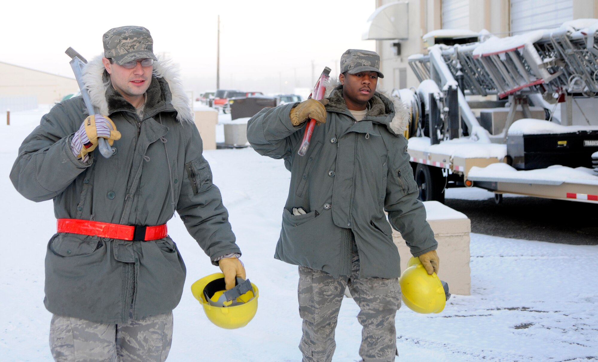 Tech. Sgt. Markus Scruggs and Airman 1st Class Chad Burton carry tools and equipment back to a government-owned-vehicle before returning back to the shop Nov. 30, 2010, Eielson Air Force Base, Alaska. For the Icemen at the 354th Civil Engineering Squadron heating ventilation air conditioning shop work never stops and daily preparation serves as practice for major repairs in the future. Both Sergeant Scruggs and Airman Burton are assigned to the 354th CES HVAC shop. (U.S. Air Force photo by/ Airman 1st Class Yash Rojas)