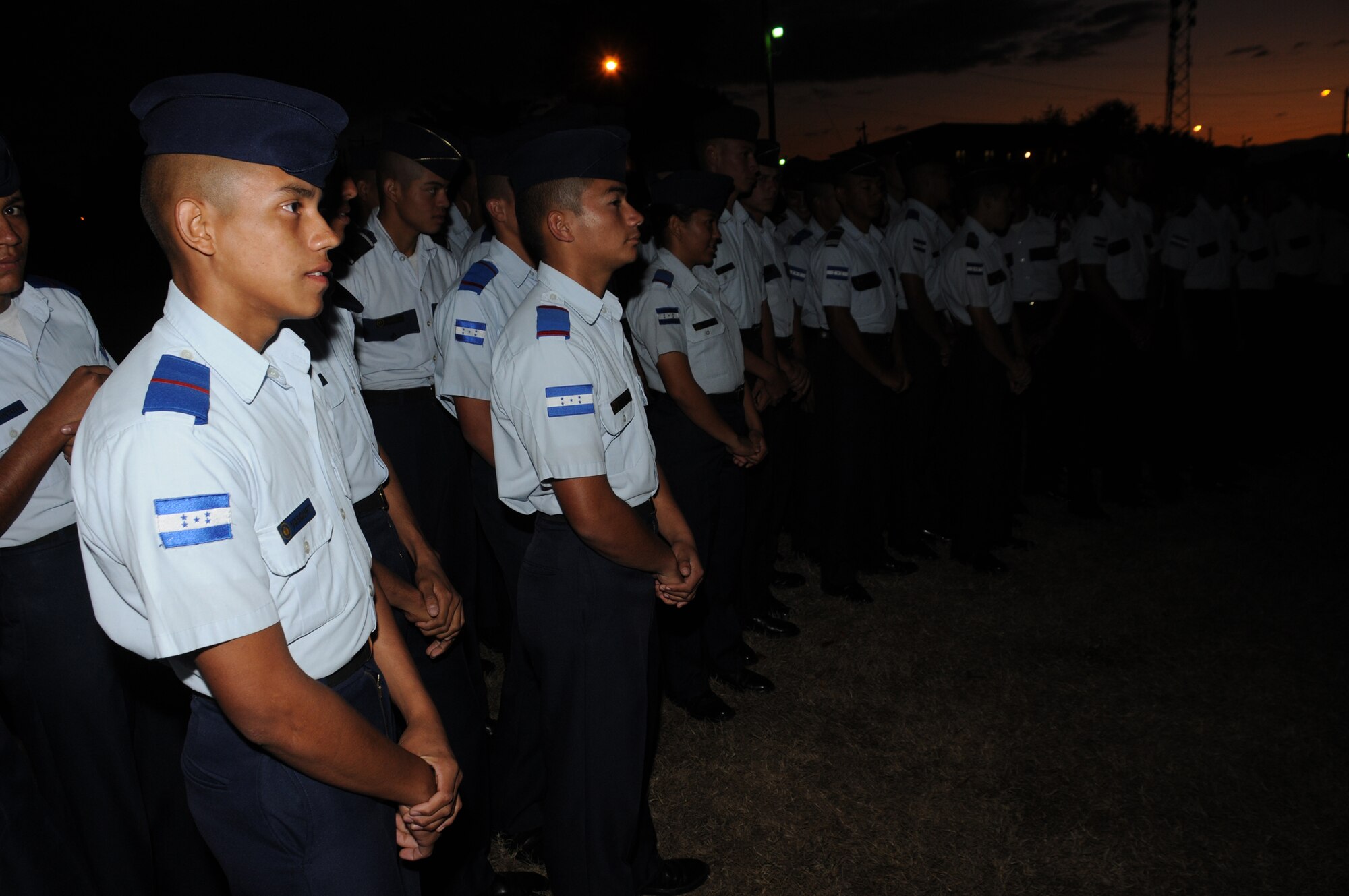 SOTO CANO AIR BASE, Honduras --  Honduran Air Force Academy cadets await the lighting of the base Christmas tree during a ceremony here Dec. 10. The base Chapel hosted the event and served holiday snacks and drinks. (U.S. Air Force photo/Tech. Sgt. Benjamin Rojek)