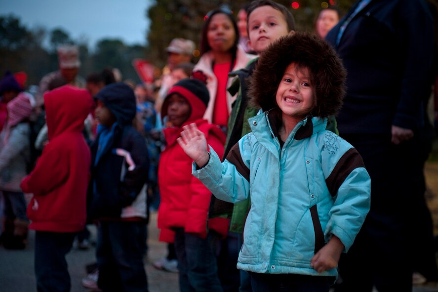 MOODY AIR BASE, Ga. -- Madisyn, daughter of Staff Sgt. Ryan Carr, 23rd Civil Engineer Squadron electrician, waves to participants of the Annual Base Tree Lighting and Holiday Parade Dec. 10. Parents and children were treated to an evening of music, hot chocolate, prize giveaways and a parade filled with holiday cheer. (U.S. Air Force photo/Senior Airman Jamal D. Sutter)(RELEASED) 