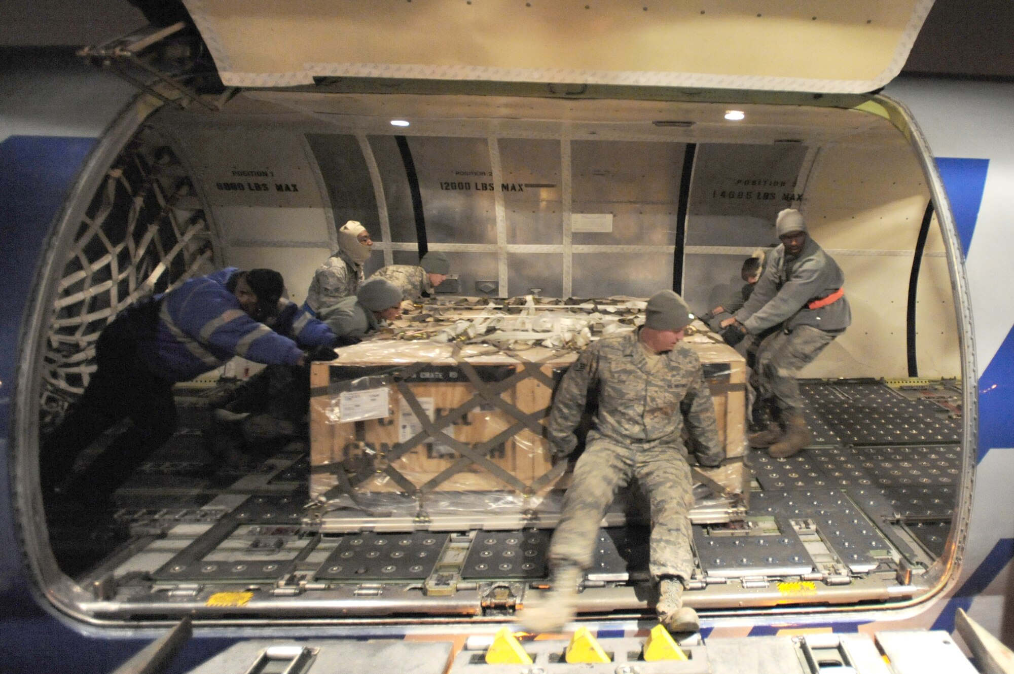Airmen from the 509th Logistics Readiness Squadron load pallets of Los Angeles-class submarine batteries into position before securing them in the cargo hold on a DC-8 cargo jet, Dec. 4, 2010, at Whiteman Air Force Base, Mo. The batteries were headed to Guam to aid a nuclear-powered submarine. (U.S. Air Force photo/Senior Airman Carlin Leslie)