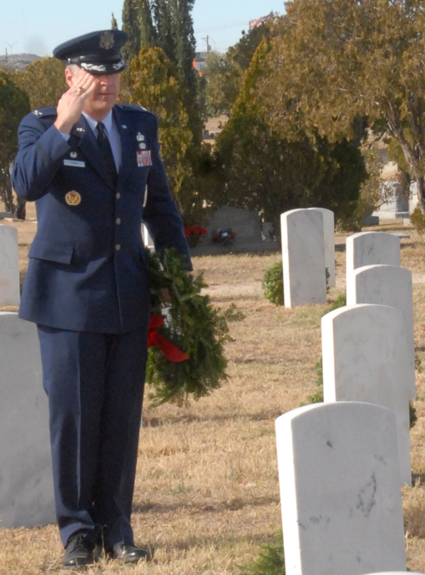 SAN ANGELO, Texas – Col. Thomas Geary, 17th Training Wing Commander, salutes after laying a wreath on a veteran’s grave in San Angelo’s Belvedere Cemetery during the National Wreaths Across America Ceremony Dec. 11.  Wreaths Across America was formed in 2007 to promote veterans remembrance.  Wreaths are placed on veterans graves during the holiday season.  (U.S. Air Force photo/Kent Cummins)