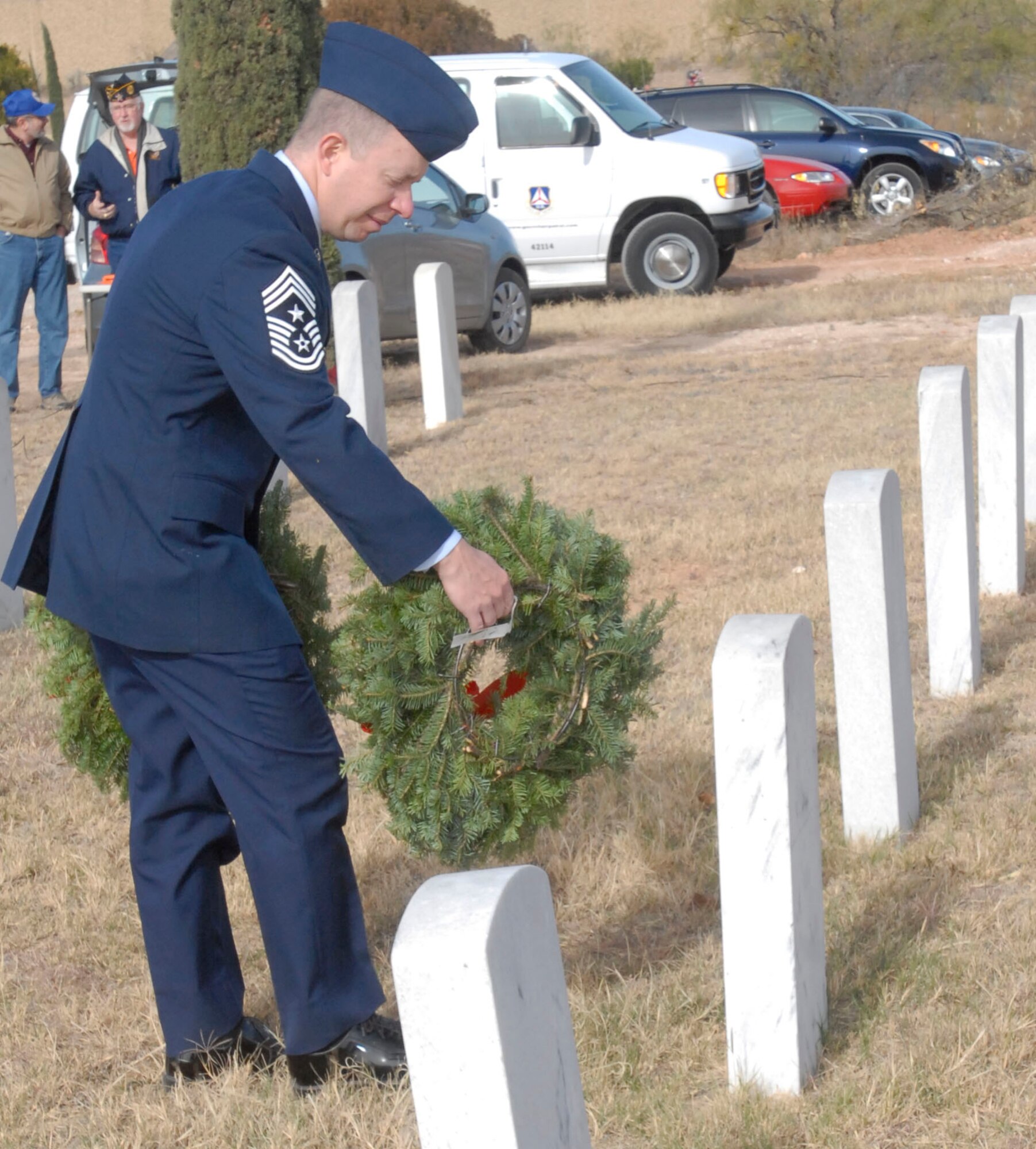 SAN ANGELO, Texas – Chief Master Sgt. Brendan Criswell, 17th Training Wing Command Chief, lays a wreath at a veteran’s grave in San Angelo’s Belvedere Cemetery during the National Wreaths Across America Ceremony Dec. 11.  Wreaths Across America was formed in 2007 to promote veterans remembrance.  Wreaths are placed on veterans graves during the holiday season.  (U.S. Air Force photo/Kent Cummins)