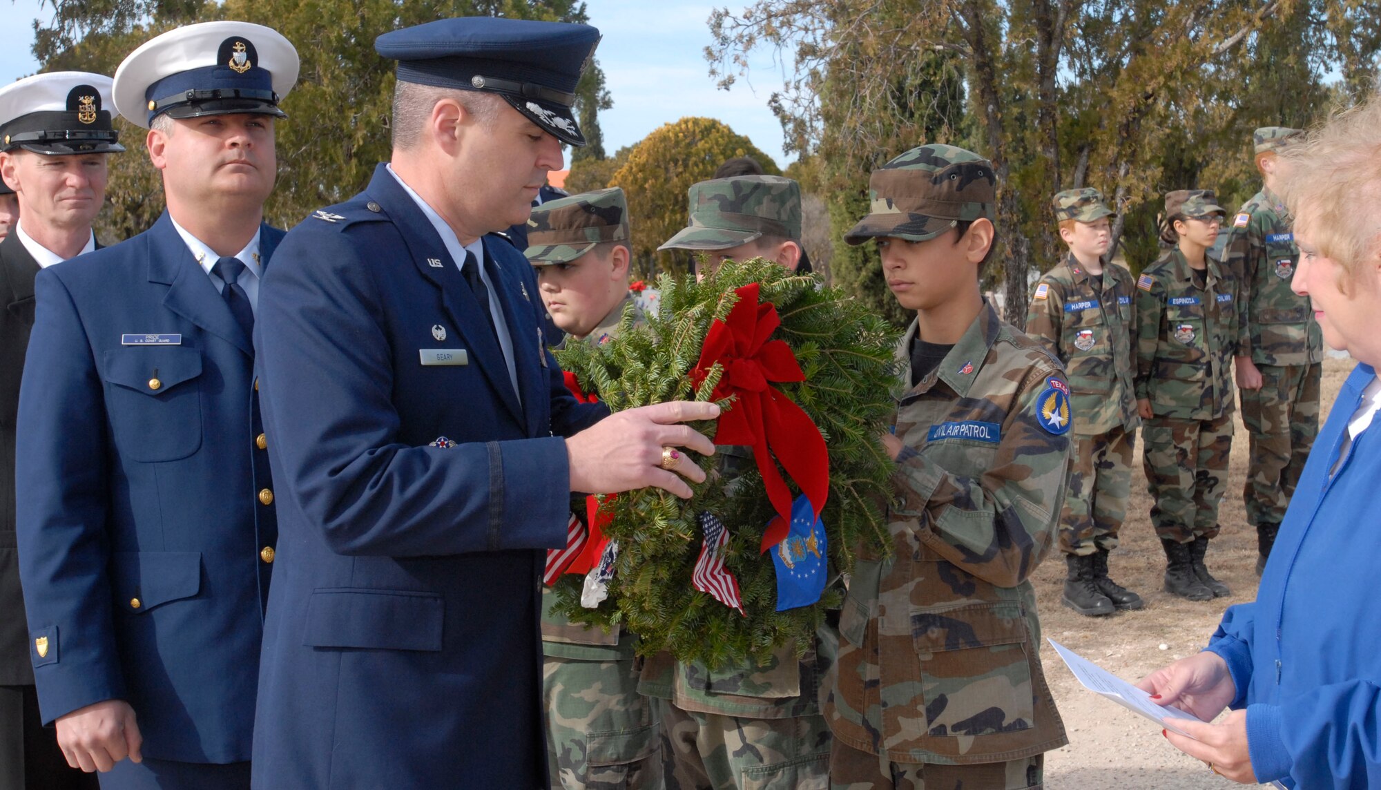 SAN ANGELO, Texas – Col. Thomas Geary, 17th Training Wing Commander, receives a wreath from a Civil Air Patrol cadet to lay at the base of San Angelo's Belvedere Cemetery flagpole during the National Wreaths Across America Ceremony Dec. 11.  Wreaths Across America was formed in 2007 to promote veterans remembrance.  Wreaths are placed on veterans graves during the holiday season. (U.S. Air Force photo/Kent Cummins)