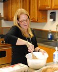 Katie Titus, a member of the Officers Spouses Club at Vance, mixes up some cookie dough during the OSC and Enlisted Spouses Group Airmen Cookie Drive, Dec. 13, at the Community Chapel Activity Center. More than 1,000 cookies will be decorated, bagged and delivered to the Airmen dormitories at Vance. Mrs. Titus is the wife of 1st Lt. Scott Titus with the 32nd Flying Training Squadron. (U.S. Air Force photo/ Joe B. Wiles)