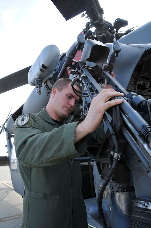 Senior Airman Jacob Ellwood conducts a preflight check on a HH-60G Pave Hawk at Moffett Federal Airfield, Calif., Nov. 06, 2010. Ellwood a flight engineer in the 129th Rescue Squadron is featured as this month's Portrait of a Professional.(Air National Guard photo by Staff Sgt. Kim E. Ramirez/Released)