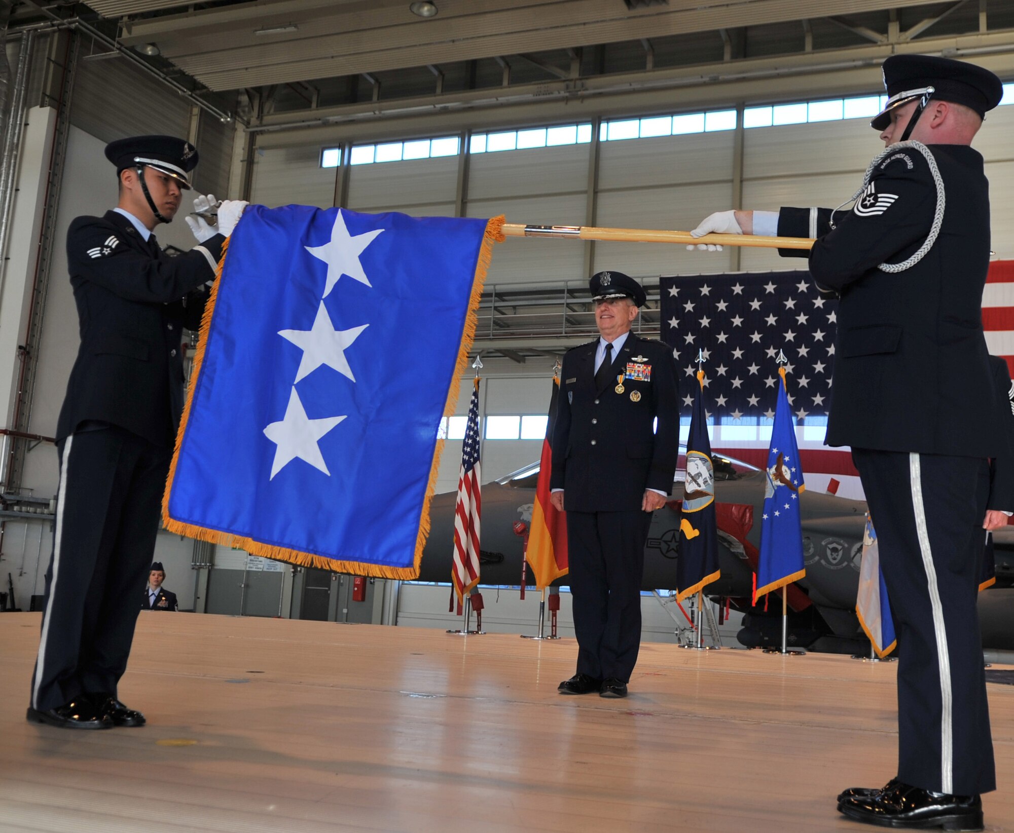 U.S. Air Force Gen. Roger A. Brady watches his flag furl during his retirement ceremony after relinquishing command of U.S. Air Forces in Europe, Ramstein Air Base, Germany, Dec. 13, 2010. Gen. Brady, relinquished command of USAFE during the change of command ceremony after providing command and control for air, space and missile defense for activities in an area of operations covering almost one-fifth of the globe which included 51 countries in Europe, Asia, the Middle East, and the Arctic and Atlantic oceans. (U.S. Air Force photo by Senior Airman Caleb Pierce)