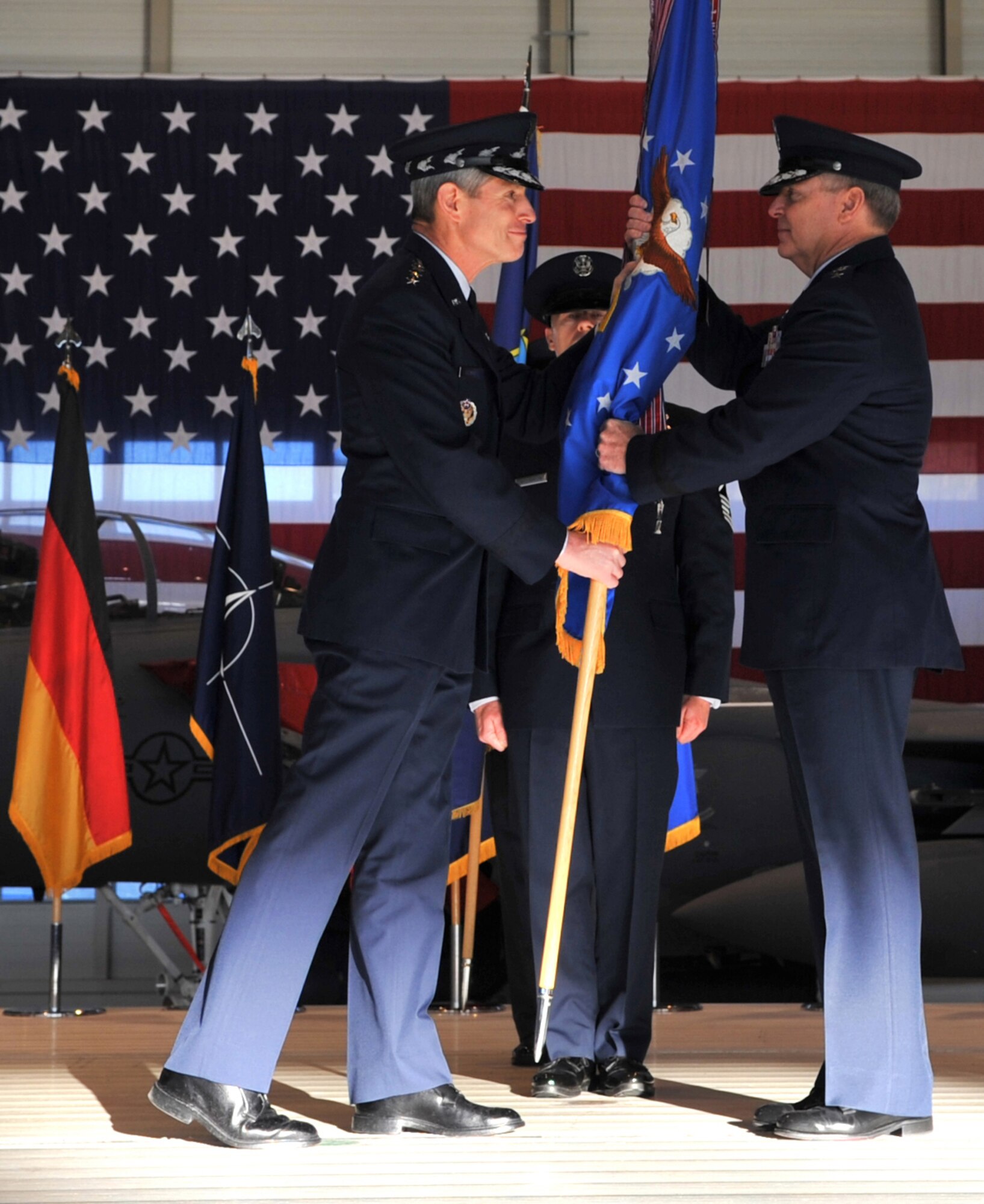 Air Force Chief of Staff Gen. Norton Schwartz gives Gen. Mark A. Welsh III, the command of U.S. Air Forces in Europe during a change of command ceremony, Ramstein Air Base, Germany, Dec. 13, 2010. Gen. Roger A. Brady, outgoing USAFE commander, relinquished command during the change of command ceremony after providing command and control for air, space and missile defense for activities in an area of operations covering almost one-fifth of the globe which included 51 countries in Europe, Asia, the Middle East, and the Arctic and Atlantic oceans. (U.S. Air Force photo by Senior Airman Caleb Pierce)