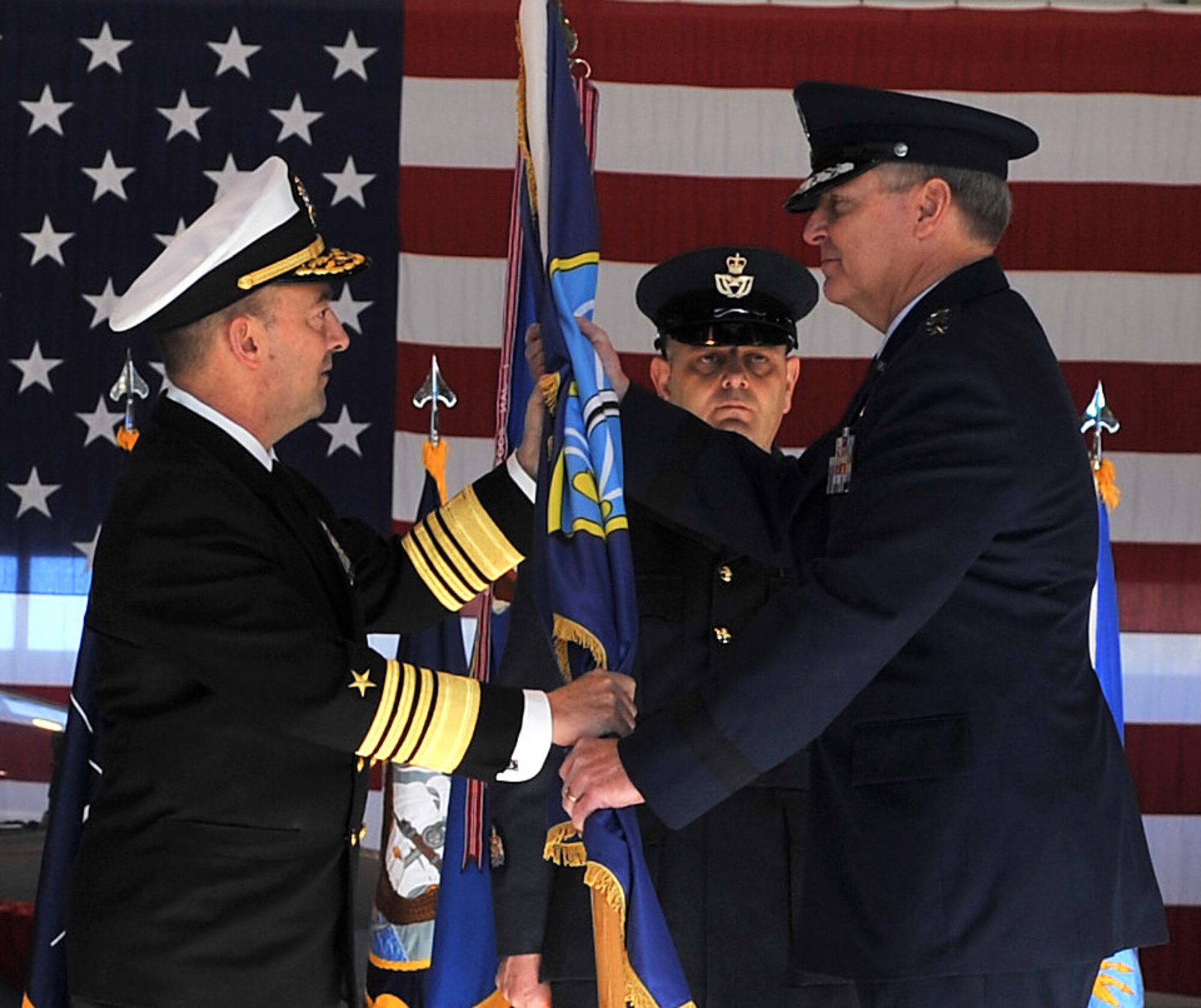 U.S. Navy Adm. James G. Stavridis, European Command and Supreme Allied Commander, Europe, gives Air Force Gen. Mark A. Welsh III, the command of U.S. Air Forces in Europe during a change of command ceremony, Ramstein Air Base, Germany, Dec. 13, 2010. Gen. Roger A. Brady, outgoing USAFE commander, relinquished command during the change of command ceremony after providing command and control for air, space and missile defense for activities in an area of operations covering almost one-fifth of the globe which included 51 countries in Europe, Asia, the Middle East, and the Arctic and Atlantic oceans. (U.S. Air Force photo by Senior Airman Caleb Pierce)