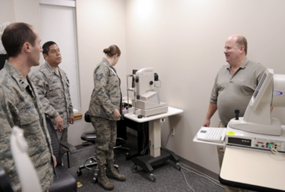 Kevin Ott, a representative from manufacturer Carl Zeiss Meditec, Inc., answers questions from Airmen about the new high-definition optical coherence tomography machine, Dec. 10, 2010, at Moody Air Force Base, Ga. The 23rd Aerospace Medicine Squadron at Moody Air Force Base, Ga., will start using the new machine for appointments in the near future, which will yield a quicker diagnosis. (U.S. Air Force photo/Airman 1st Class Douglas Ellis)