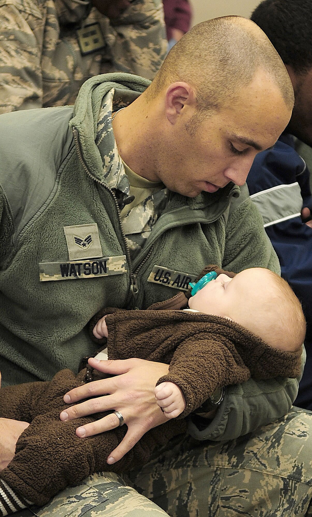 Senior Airman David Watson takes a moment to say goodbye to his 3-month-old son, Mikah, Dec. 6, 2010, at Moody Air Force Base, Ga. This is the first deployment to Afghanistan for the 820th Base Defense Group. Airman Watson is an 822nd Base Defense Squadron fire team member. (U.S. Air Force photo/Senior Airman Stephanie Mancha)
