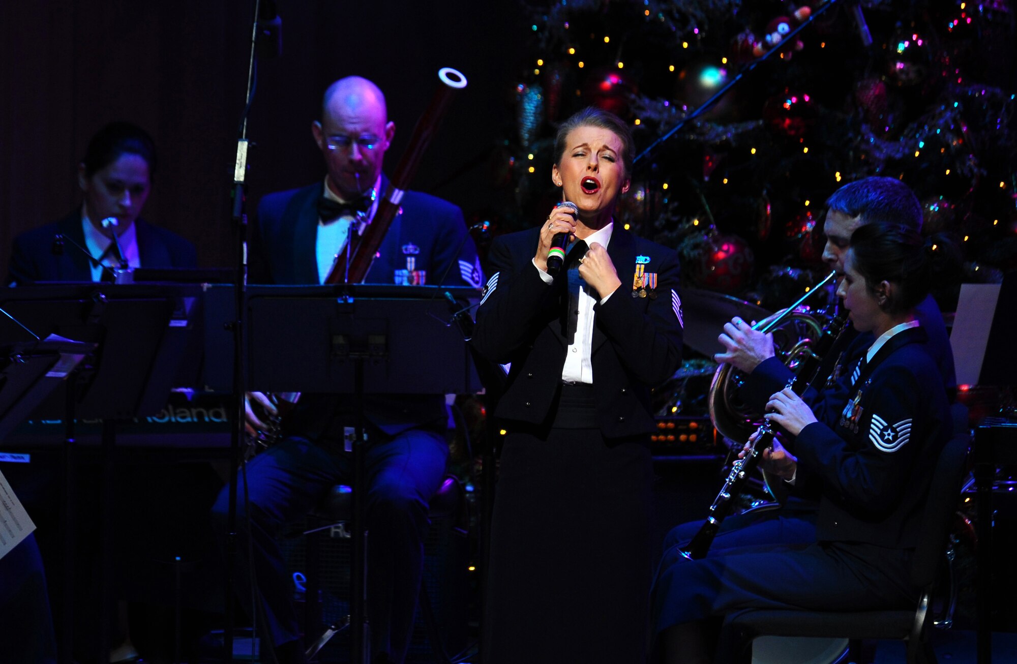 OFFUTT AIR FORCE BASE, Neb. ? Tech. Sgt. Krista Joyce, vocalist with the Heartland of America Band, performs at the ?Christmas in Reel Time? annual holiday concert held at the Holland Performing Arts Center in downtown Omaha, Dec. 9. Sergeant Joyce is one of five vocal soloists during the concert, most of whom also play instruments in other Heartland of America Band ensembles.  U.S. Air Force Photo by Josh Plueger (Released)