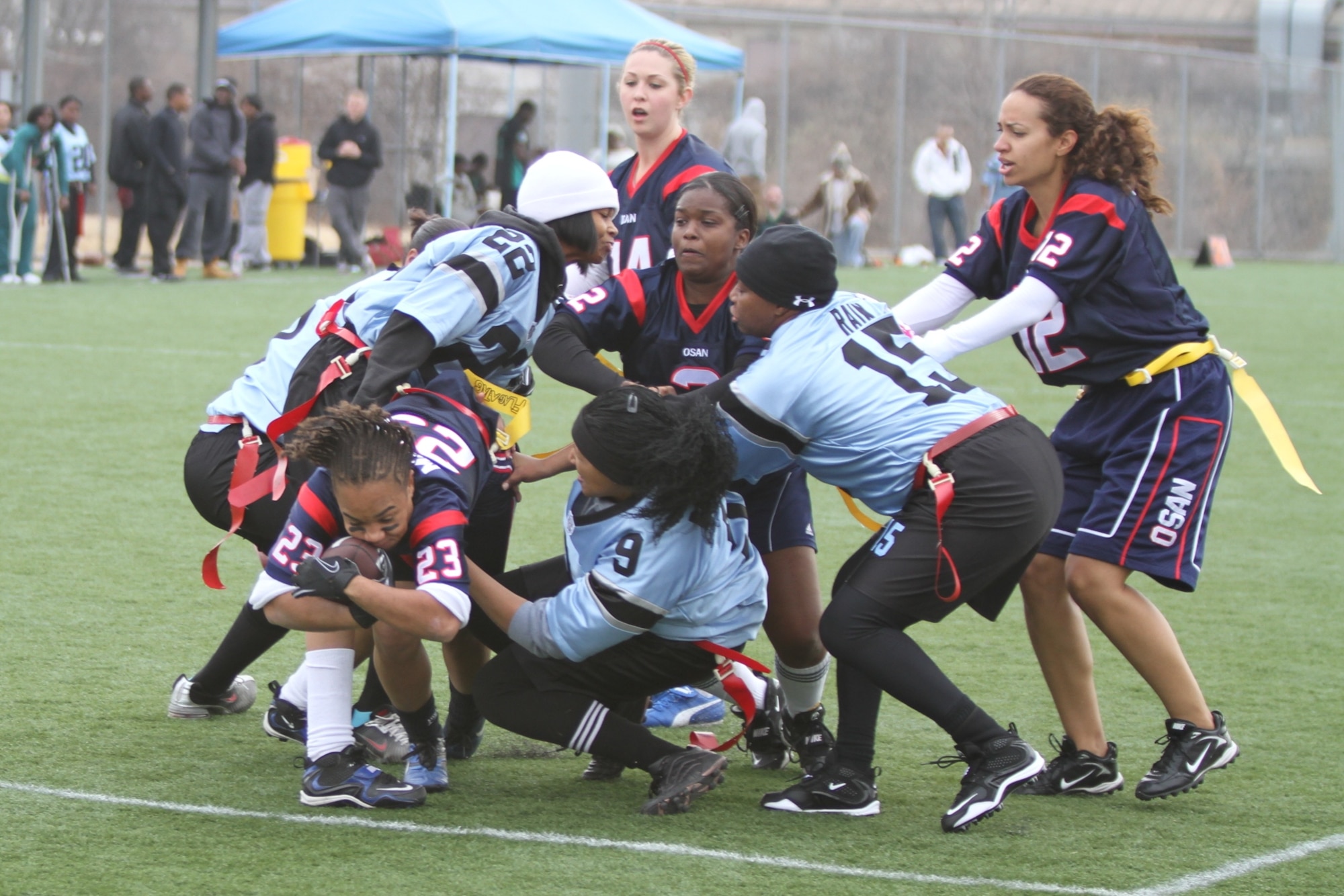 Osan linesmen Aimee Roth, Tina Meyers and Courtney McBurney help to penetrate Humphreys’ defense as Lauryn McCoy dives to score a touchdown during a playoff game Dec. 5. (Courtesy photo)