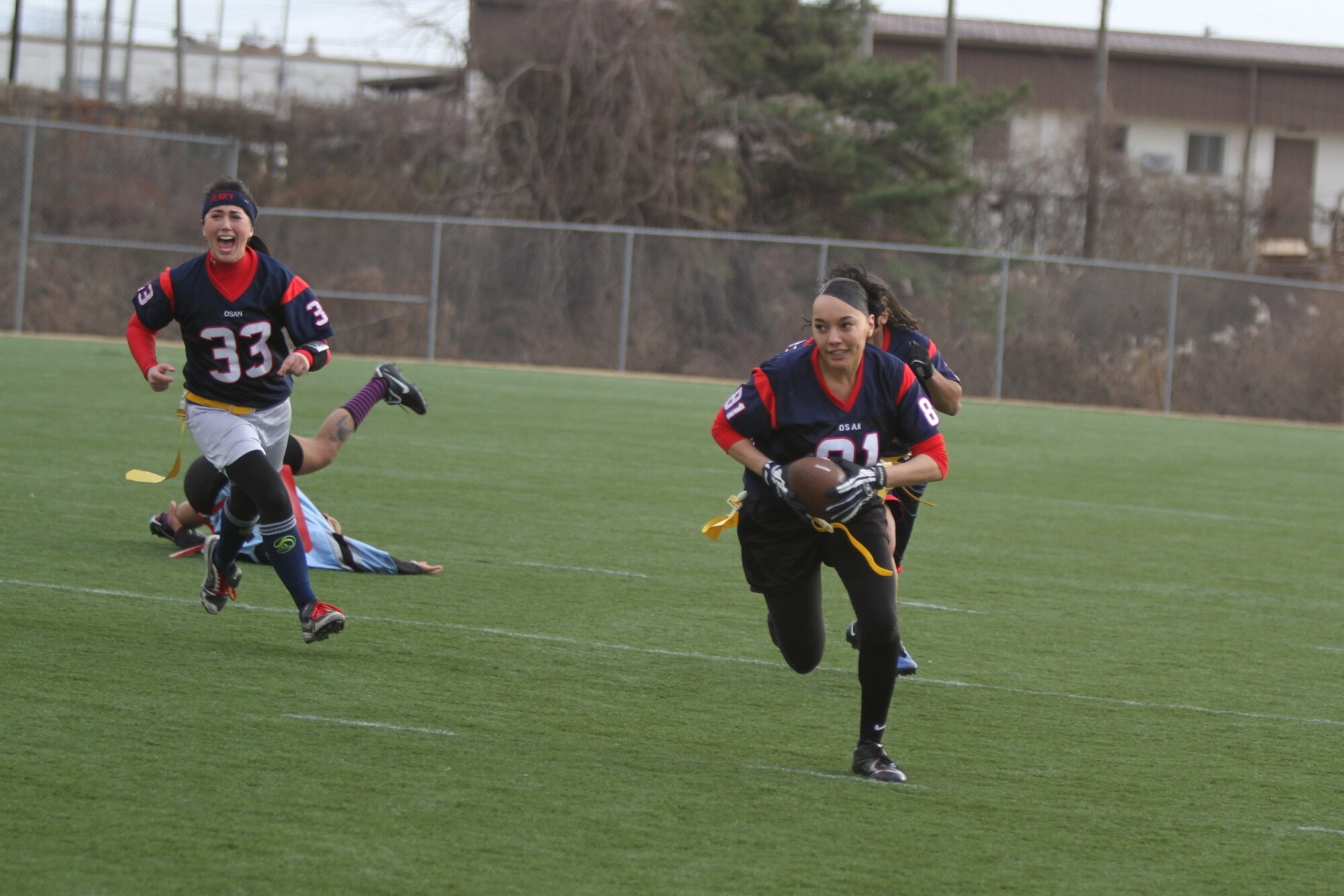 Samantha Perry cheers on Vanessa Valente-Perryman during a pass interception in the championship game against the Camp Humphreys II team Dec. 5. (Courtesy photo)