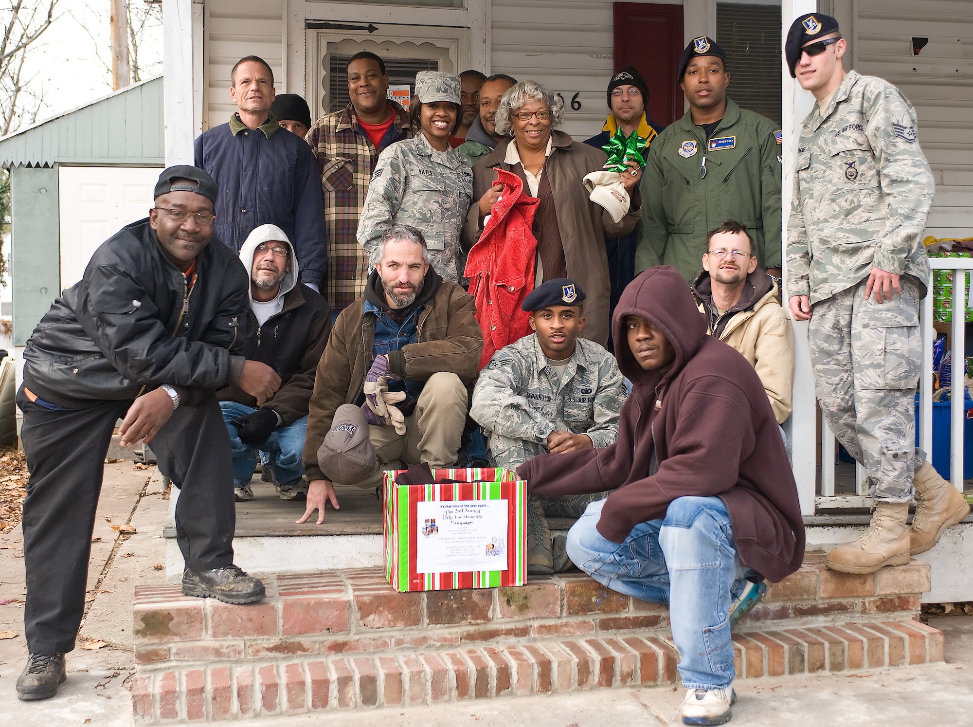 Members from Dover Air Force Base, Del., and residents of a local homeless shelter come together for a group photo after delivering donations Dec. 3, 2010. To date, the "Help the Homeless" campaign has collected 641 food items, 62 coats and 45 toys. (U.S. Air Force photo by Roland Balik/Released)