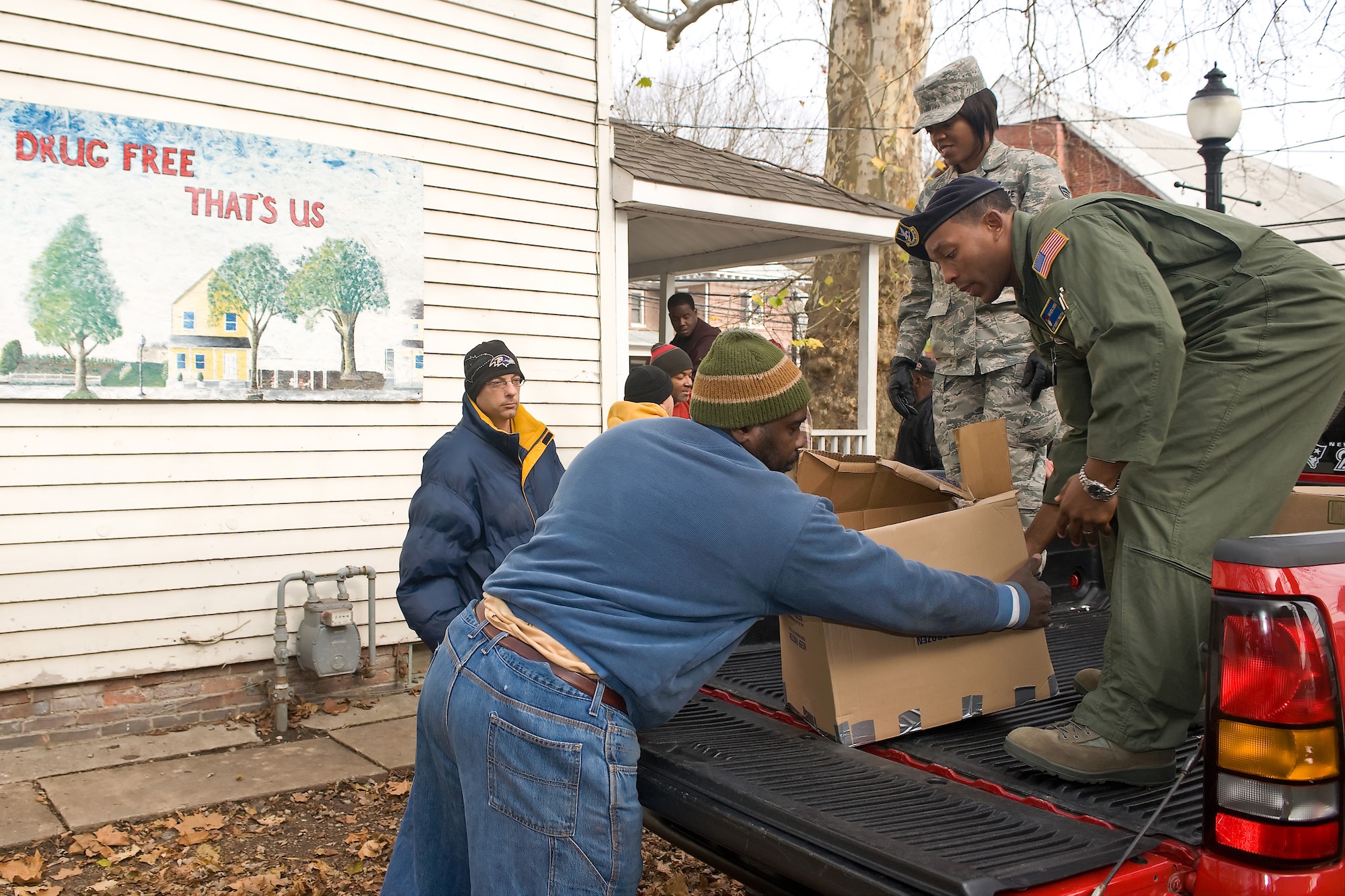 Members from Dover Air Force Base, Del., and residents of a local homeless shelter unload donations for the "Help the Homeless" campaign, Dec. 3, 2010. To date, the "Help the Homeless" campaign has collected 641 food items, 62 coats and 45 toys. (U.S. Air Force photo by Roland Balik/Released)