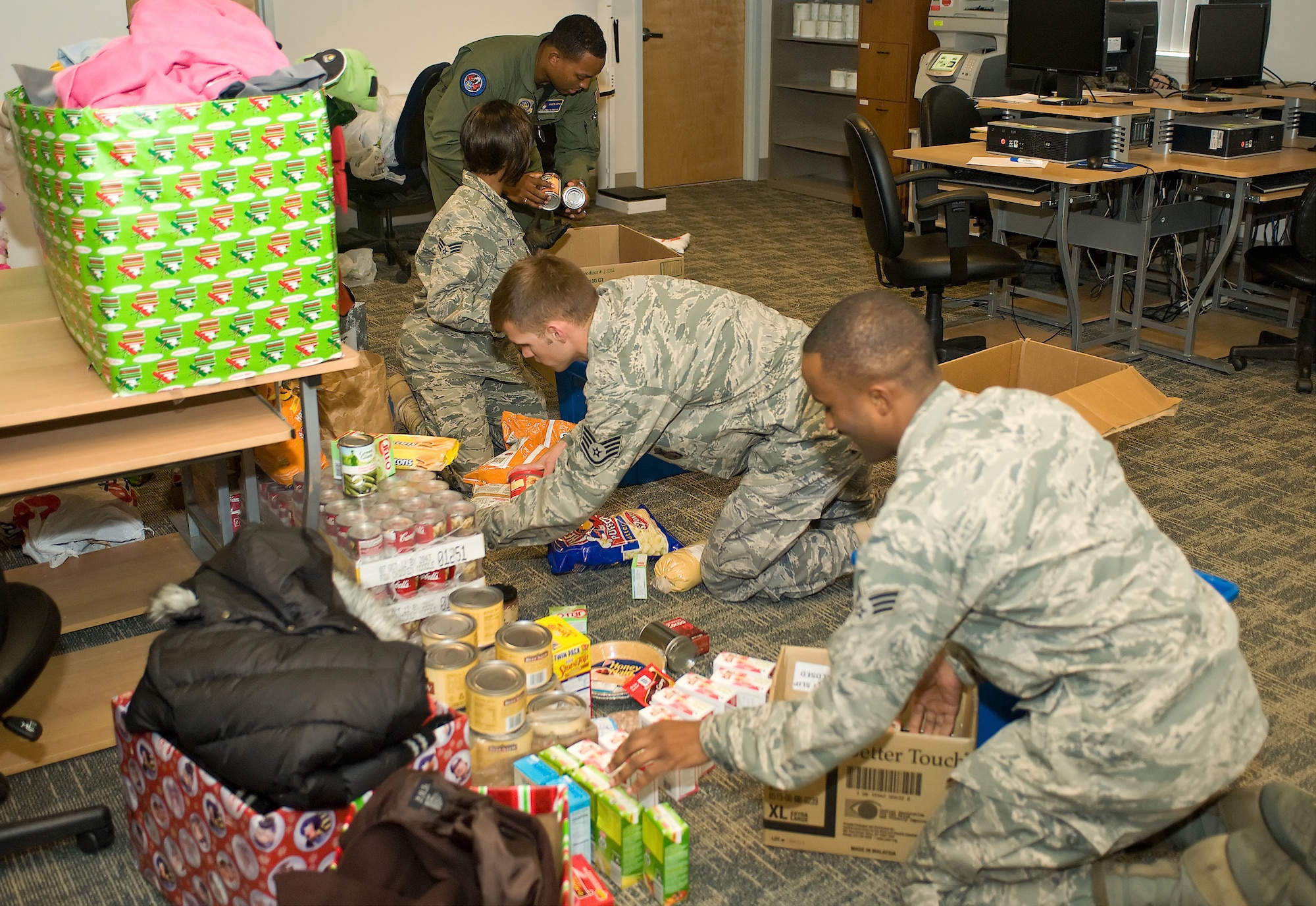 Members from Dover Air Force Base, Del., package donations for a local homeless shelter Dec. 3, 2010. To date, the "Help the Homeless" campaign has collected 641 food items, 62 coats and 45 toys. The campaign ends Dec. 23. (U.S. Air Force photo by Roland Balik/Released)