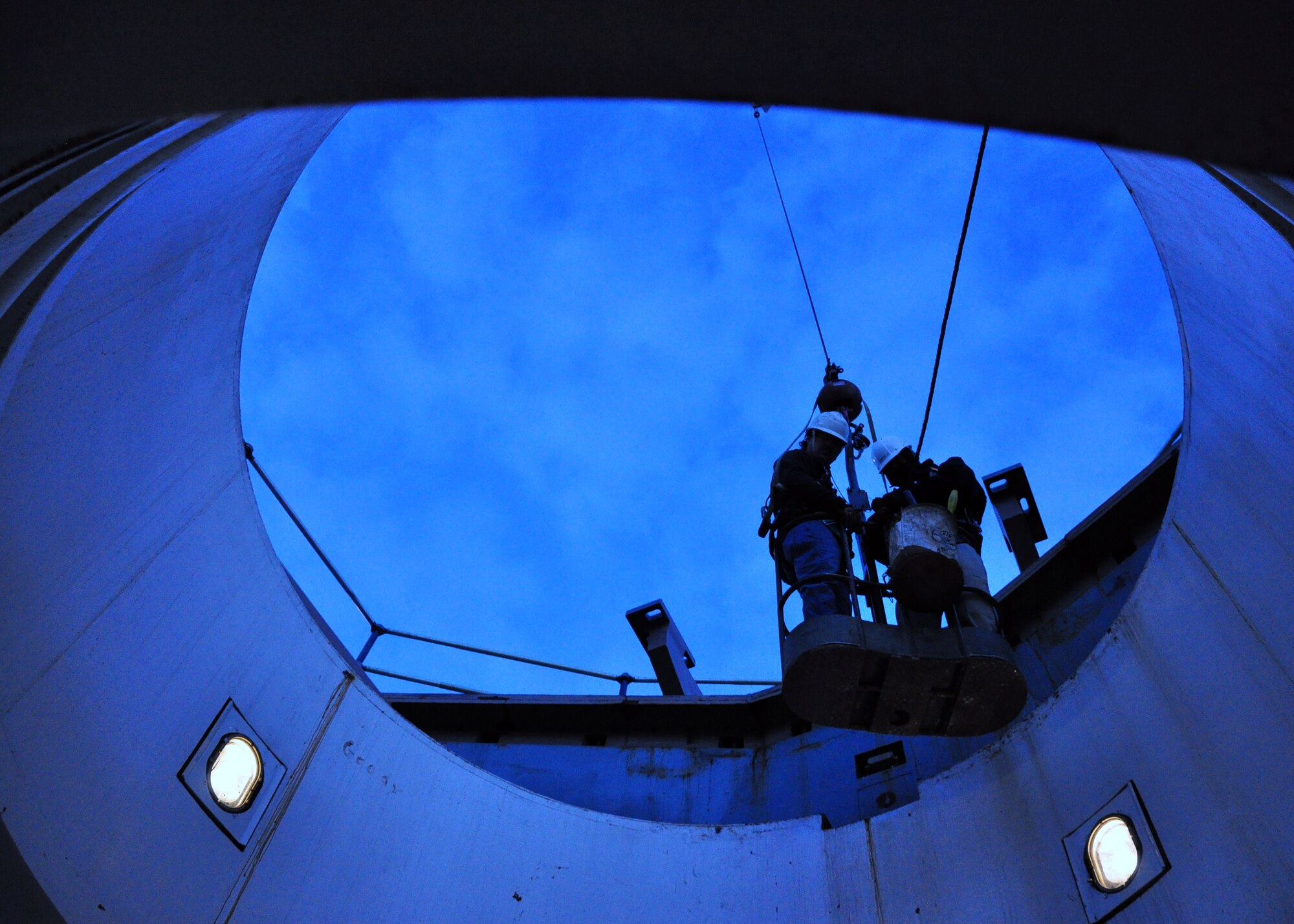 A two-man maintenance crew from Hill Air Force Base, Utah is lowered into Warren's training launch facility Dec. 7 at Uniform-1. The team was here to remove the missile support system in order to ship it to Vandenberg AFB, Calif., so that the MSS could be refurbished. This was the first time a MSS has been removed from a training site here. (U.S. Air Force photo by Staff Sgt. Chad Thompson)