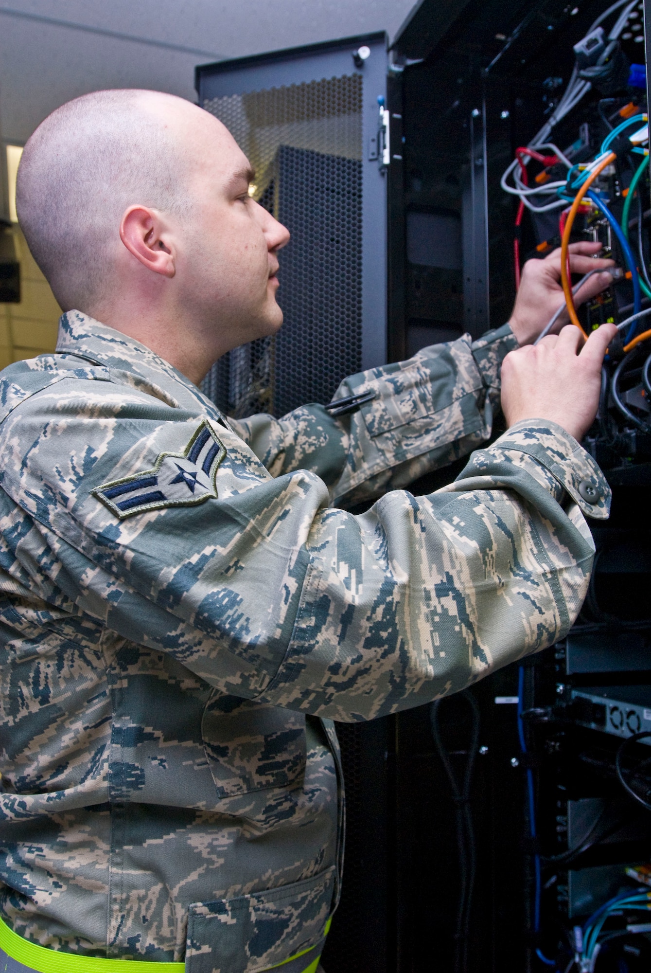 Airman 1st Class Jay Winslow, a 19th Communications Squadron network administrator, tests a network connection on an Active Directory Exchange suite Dec. 10, 2010, at Little Rock Air Force Base, Ark.  The Latrobe, Pa. native, installed vital servers toward transitioning the base network to the more secure centralized Air Force Network. (U.S. Air Force photo by Staff Sgt. Nestor Cruz)