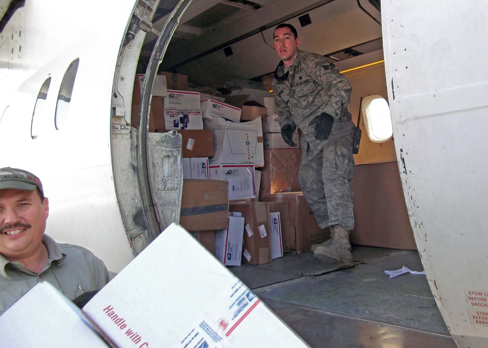 Senior Airman Mario Zamora-Ceja, 70th Aerial Port Squadron, unloads mail from an aircraft at Bagram Air Base, Afghanistan. Short Takeoff and Landing team at Bagram recently set the record for most mail shipped in a single day with 49791 tons. STOLS aircraft are used to send mail, small amounts of cargo, and personnel to dispersed Foreward Operating Bases in Afghanistan.  59 Mako Porters from the 482nd Fighter Wing are currently deployed to Bagram and two to Manas for 4 months.  They  will begin arriving home in January. (US Air Force photo)
