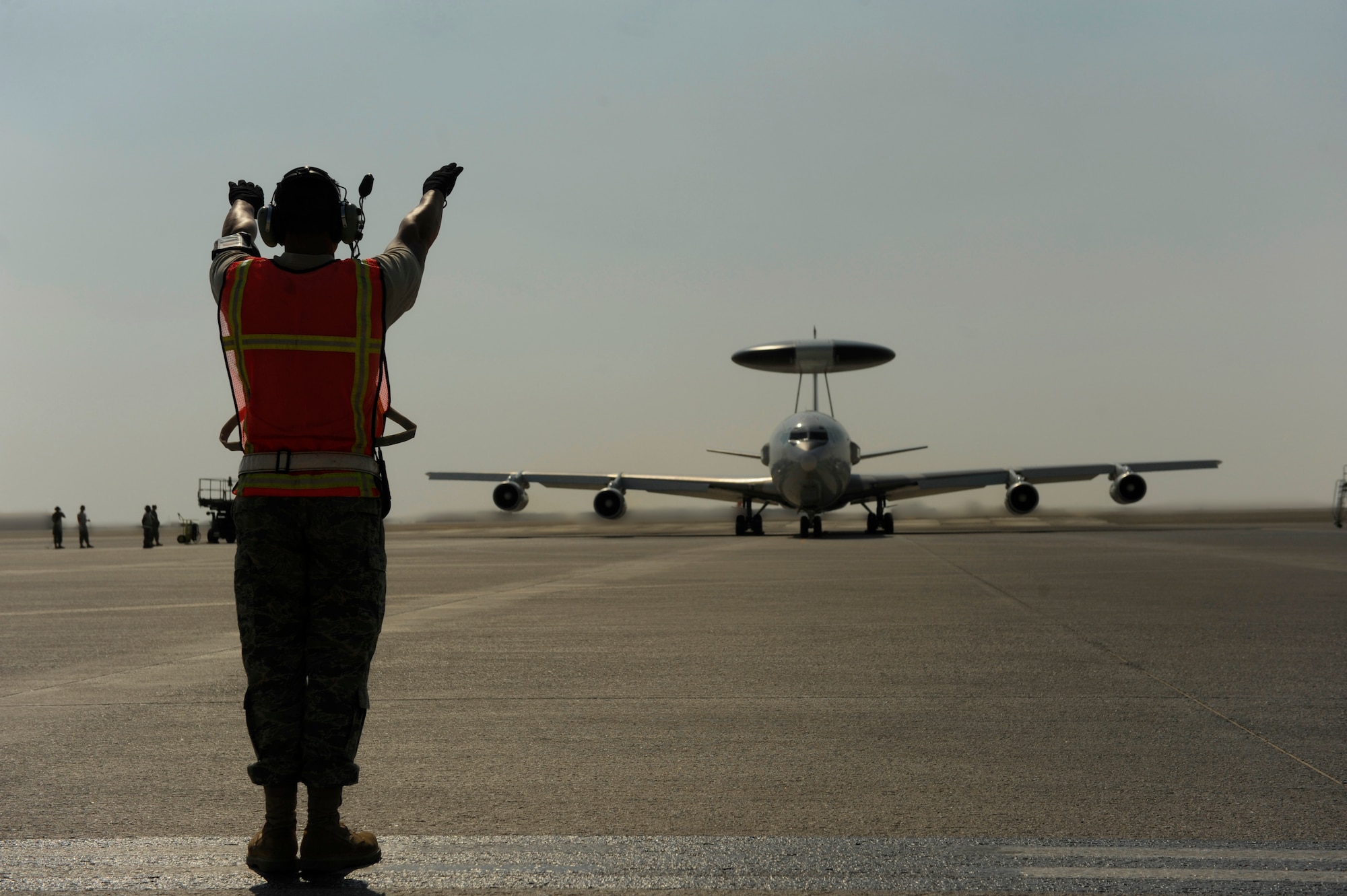 U.S. Air Force Staff Sgt. Chase Shands, 380th Aircraft Maintenance Squadron, marshals an E-3 Sentry for takeoff at an undisclosed location in Southwest Asia, Nov. 23, 2010.  The E-3 is an Airborne Warning and Control System (AWACS) that provides all-weather surveillance, command, control and communications.  The maintainers are deployed from Tinker Air Force Base, Okla.  (U.S. Air Force Photo/Staff Sgt. Eric Harris) (RELEASED)