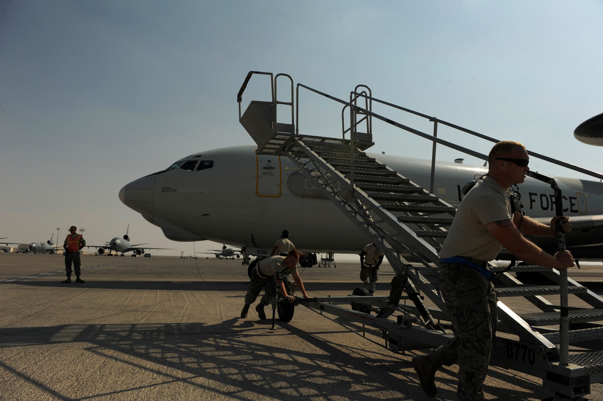 U.S. Air Force maintainers from the 380th Aircraft Maintenance Squadron move a mobile staircase away from an E-3 Sentry as it prepares for takeoff at an undisclosed location in Southwest Asia, Nov. 23, 2010.  The E-3 is an Airborne Warning and Control System (AWACS) that provides all-weather surveillance, command, control and communications.  The maintainers are deployed from Tinker Air Force Base, Okla.  (U.S. Air Force Photo/Staff Sgt. Eric Harris) (RELEASED)