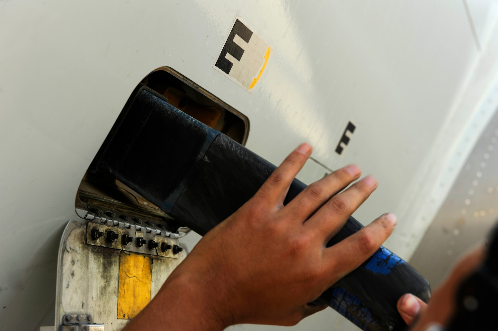 U.S. Air Force Senior Airman Joshua Escobar, 380th Aircraft Maintenance Squadron, plugs an external power unit into an E-3 Sentry in order to perform flight systems maintenance at an undisclosed location in Southwest Asia, Nov. 23, 2010.  The E-3 is an Airborne Warning and Control System (AWACS) that provides all-weather surveillance, command, control and communications.  The maintainers are deployed from Tinker Air Force Base, Okla.  (U.S. Air Force Photo/Staff Sgt. Eric Harris) (RELEASED)
