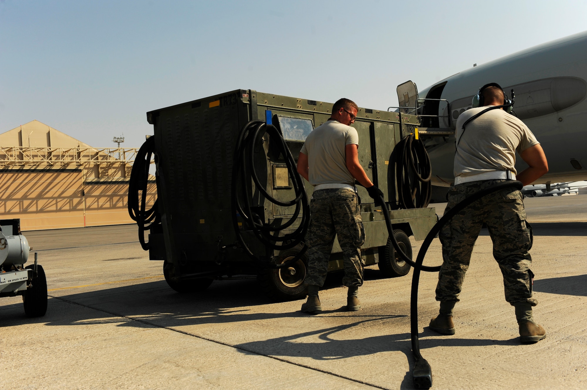 U.S. Air Force maintainers from the 380th Aircraft Maintenance Squadron prepare to plug an external power unit into an E-3 Sentry in order to perform flight systems maintenance at an undisclosed location in Southwest Asia, Nov. 23, 2010.  The E-3 is an Airborne Warning and Control System (AWACS) that provides all-weather surveillance, command, control and communications.  The maintainers are deployed from Tinker Air Force Base, Okla.  (U.S. Air Force Photo/Staff Sgt. Eric Harris) (RELEASED)