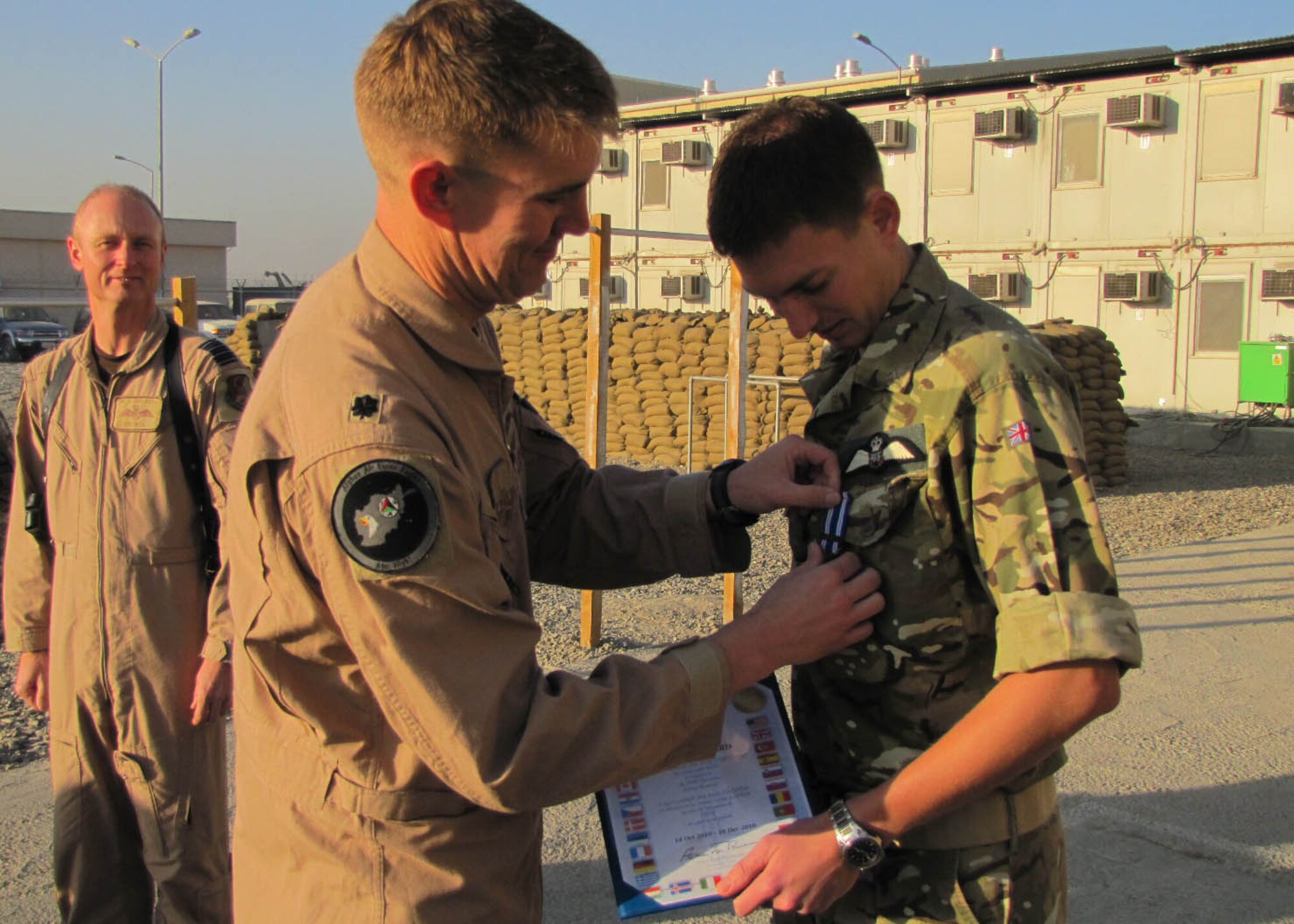 KABUL, Afghanistan - Members of NATO Air Training Command-Afghanistan celebrated the accomplishments of Royal Air Force Flying Officers Matthew Smyth and Lee Southward and the impact they had on the Thunder Lab at Kabul, Afghanistan during their two months in country, Dec.13. Both officers were presented with the NATO medal for their actions. (U.S. Navy Photo by MC3 Jared E. Walker/RELEASED).