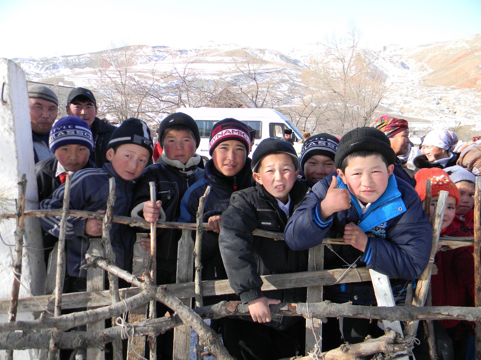 OSH, Kyrgyzstan - Local children display their appreciation during Operation Warm & Dry II Dec. 8.  Transit Center at Manas Airmen teamed up with U.S. Office of Military Cooperation, Joint Distribution Effort, Kyrgyz Ministry of Emergency Situations, Osh Rayon governmental leaders and the Kyrgyz police department to distribute 3,500 pounds of clothing, 1,000 coats and 1,000 blankets to Toguz-Bulak and Sary-Kungoi villages. The clothing was donated by Americans and the coats and blankets were purchased with Department of Defense funding for this humanitarian assistance program. (U.S. Air Force photo/Senior Airman Jennifer Archambault)