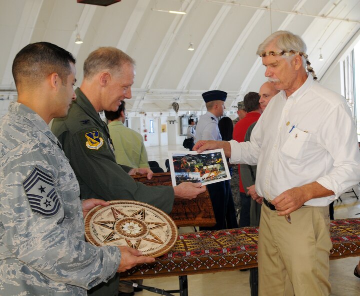 Mr. Bruce Best, University of Guam researcher, presents Col. Paul ?Otto? Feather, 374th Airlift Wing commander, Yokota Air Base, Japan, with gifts on behalf of Micronesian Islanders for their continued support during the Operation Christmas Drop Push Ceremony at Andersen Air Force Base, Guam, Dec. 13. Operation Christmas Drop is the Air Force?s longest-running humanitarian which began in 1952. Airmen today continue the tradition delivering supplies to remote islands of the Commonwealth of the Northern Marianas Islands, Yap, Palau, Chuuk and Pohnpei. (U.S. Air Force photo/ Senior Airman Nichelle Anderson)