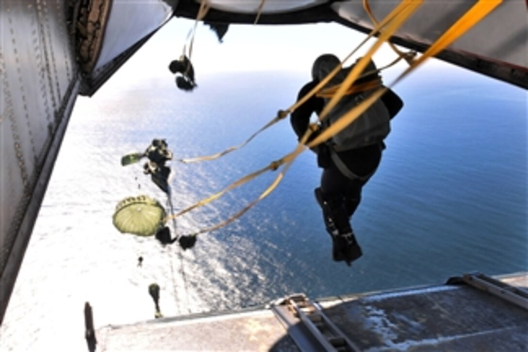 U.S. Navy Explosive Ordnance Disposal technicians with Explosive Ordnance Disposal Mobile Unit 11, Detachment 15, perform a static line water drop out of a C-2A Greyhound carrier-onboard-delivery aircraft over San Diego, Calif., on Dec. 8, 2010.  Explosive Ordnance Disposal personnel are trained in explosives, diving and parachuting.  