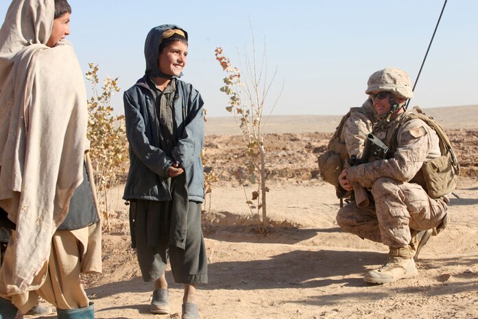 Staff Sgt. Cary Anderson, a team leader with Lima Company, 3rd Battalion, 25th Marine Regiment, meets with children during a joint patrol in the village of Habibabad, Dec. 13. Marines and Danish soldiers have been training a unit of Afghan National Army soldiers in tactics and patrolling, while stopping to discuss concerns with the locals.
