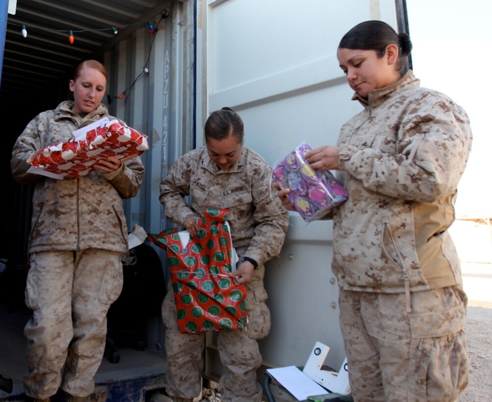 Marines with 1st Marine Logistics Group (Forward), open Secret Santa holiday gifts at Camp Leatherneck, Afghanistan, Dec. 13. Petty Officer 1st Class James Bowes, a native of Port Angeles, Wash., collected the holiday gifts from various organizations in the United States to distribute to the service members in his unit as a way of spreading holiday cheer while they are deployed.