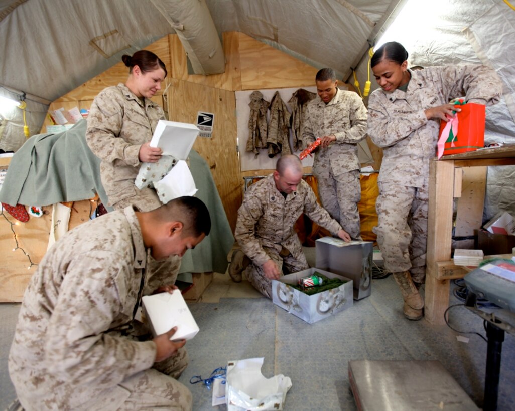 Marines with 1st Marine Logistics Group (Forward), open Secret Santa holiday gifts at Camp Leatherneck, Afghanistan, Dec. 13. Petty Officer 1st Class James Bowes, a native of Port Angeles, Wash., collected the holiday gifts from various organizations in the United States to distribute to the service members in his unit as a way of spreading holiday cheer while they are deployed.