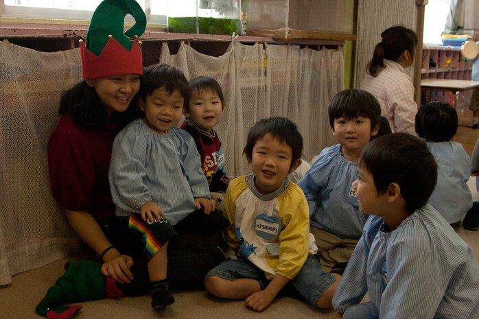 Lance Cpl. Michelle Thach interacts with the Japanese children at Josho Hoikuen school in Iwakuni, Japan, Tuesday. The children flocked to Thach as she played and jokedy around with them. Different members from the Installation Personnel Administration Center here visit the school once a month to spend time with the children.