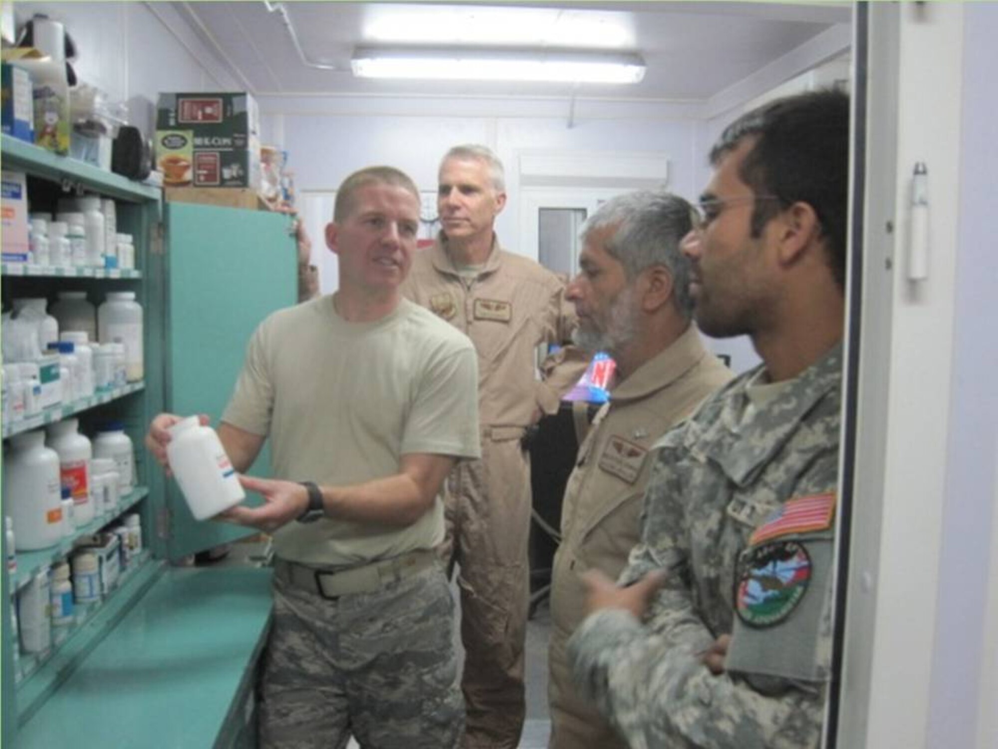 KANDAHAR, Afghanistan - A U.S. Air Force Airman describes procedures in the pharmacy to the Kandahar Air Wing Flight Surgeon and Dentist during a visit the two had to the 451st Air Expeditonary Wing Medical Clinic to see how a USAF medical clinic conducts operations. (Photo courtesy of US Air Force/RELEASED)
