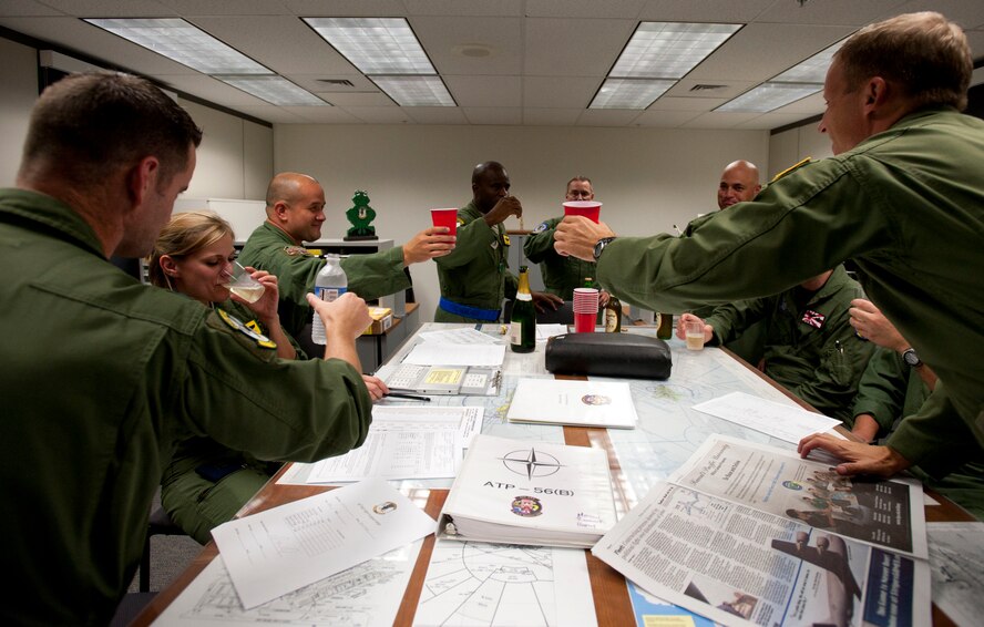 Lt. Col. Brian Hill (center), 96th Air Refueling Squadron commander, toasts to a successfully completed mission Dec. 14 at Joint Base Pearl Harbor-Hickam, Hawaii. During the squadron's first operational mission, a 96th ARS KC-135 Stratotanker joined a KC-135 from the Iowa Air National Guard as part of a two-ship formation to refuel two B-52 Stratofortresses on the way to Guam.(U.S. Air Force photo/Staff Sgt. Nathan Allen)